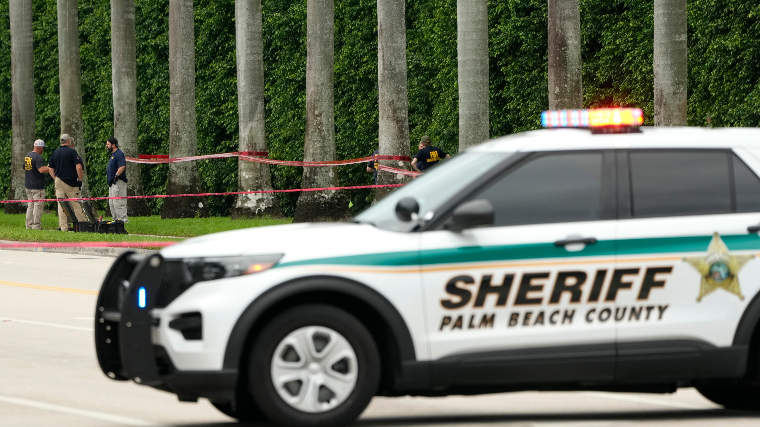 Law enforcement officials work at the scene at the Trump International Golf Club in the aftermath of the apparent assassination attempt of Republican presidential nominee and former President Donald Trump Tuesday, Sept. 17, 2024, in West Palm Beach, Fla. (AP Photo/Lynne Sladky)