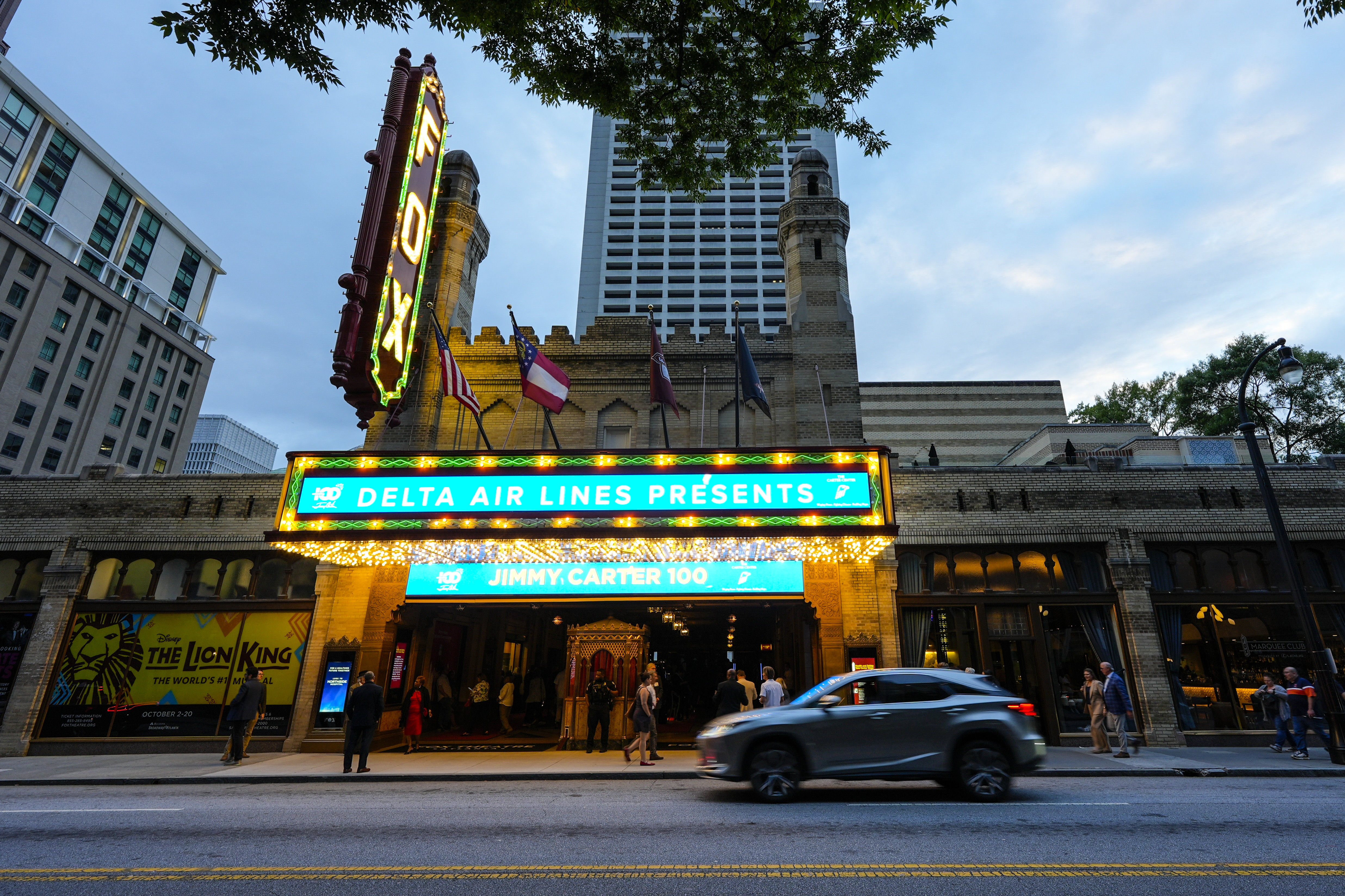 People wait in line ahead of a "Jimmy Carter 100: A Celebration in Song," concert at the Fox Theatre, Tuesday, Sept. 17, 2024, in Atlanta. Former President Carter turns 100-years old on Oct. 1. (AP Photo/Mike Stewart)