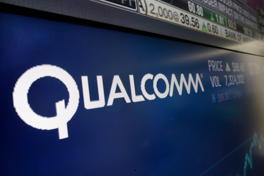 FILE - This Wednesday, Feb. 14, 2018 file photo shows the logo for Qualcomm on a screen at the Nasdaq MarketSite, in New York. (AP Photo/Richard Drew, File)