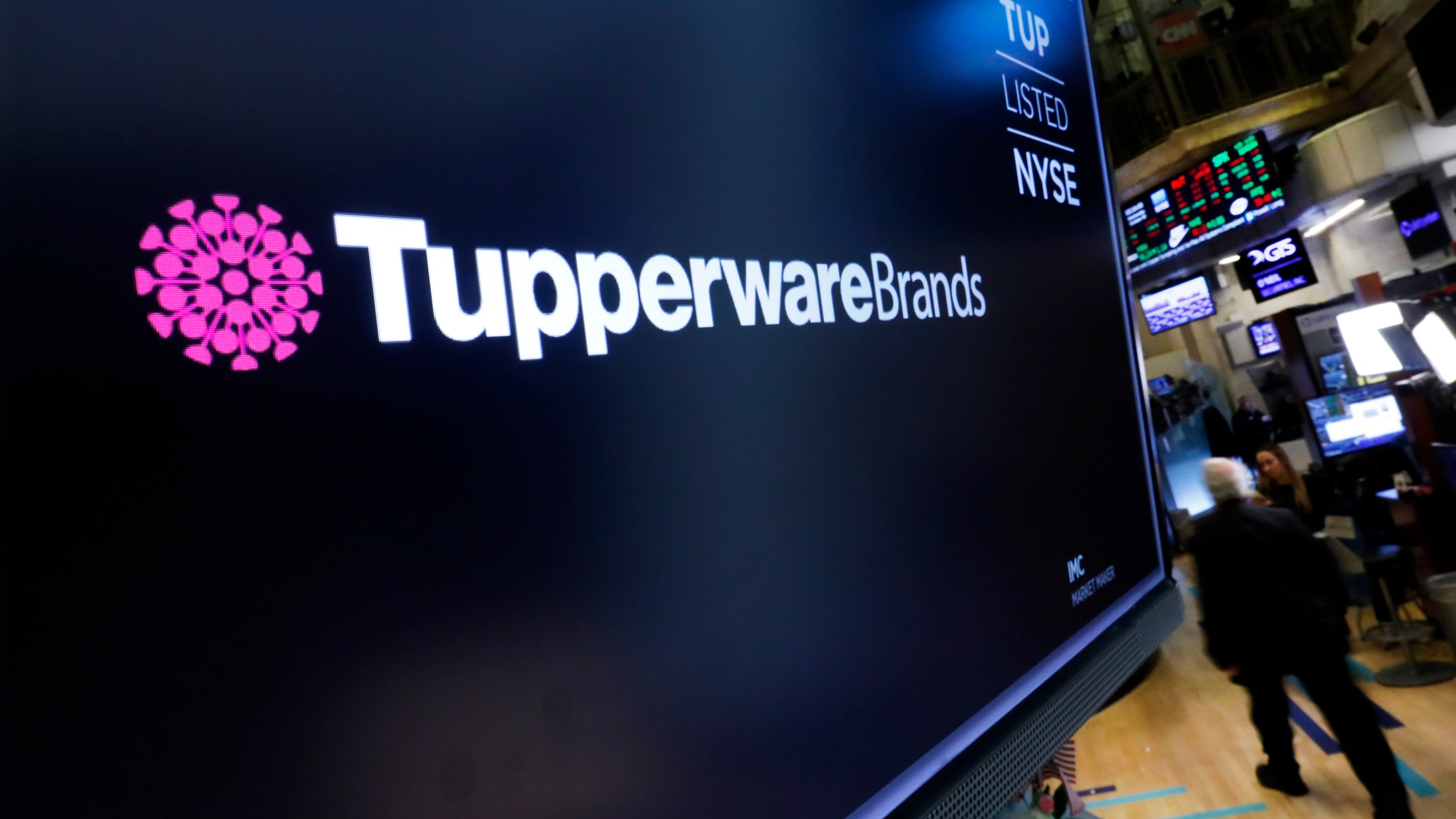 FILE - The logo for Tupperware Brands appears on a monitor on the floor of the New York Stock Exchange on Oct. 30, 2019. (AP Photo/Richard Drew, File)