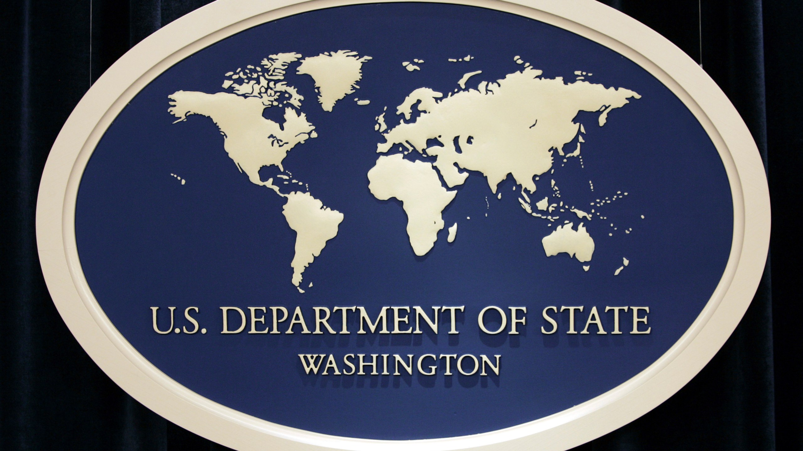 FILE - U.S. Department of State sign is seen at the State Department in Washington, Aug. 10, 2006. The State Department’s internal watchdog says that officials did not follow proper protocol when handling the security clearance suspension of the U.S. special envoy for Iran following allegations last year that he may have mishandled classified information. (AP Photo/Charles Dharapak, File)