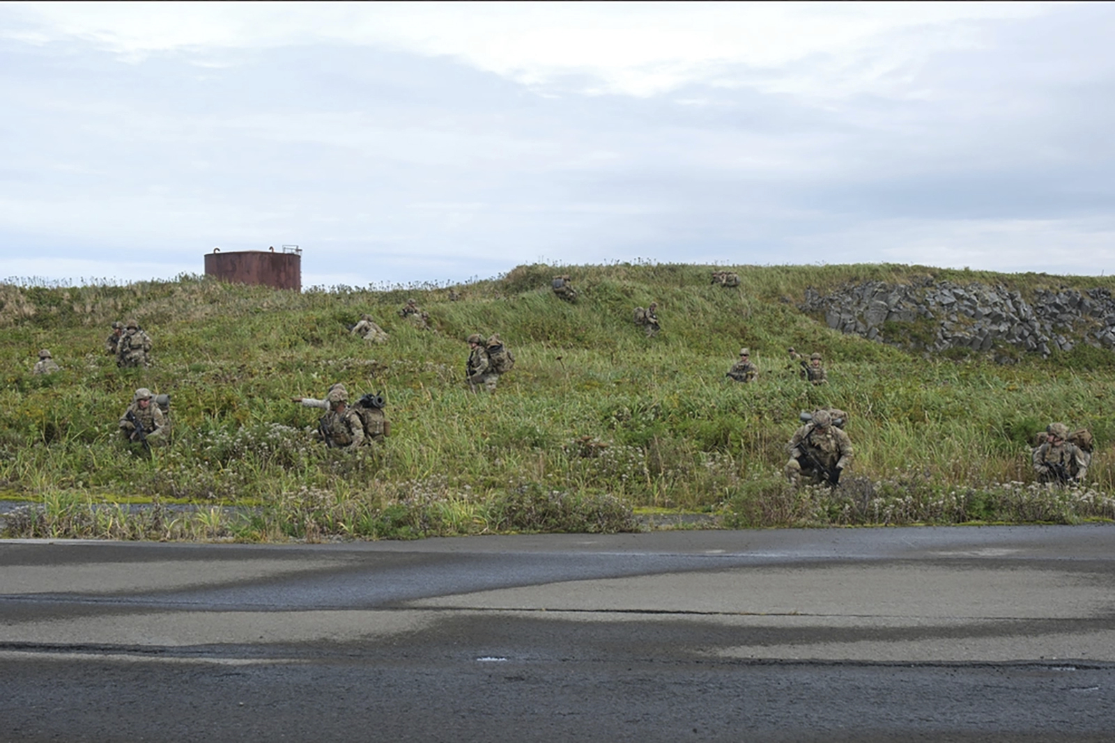 In this image released by the U.S. Army, U.S. Army soldiers assigned to 1st Battalion, 501st Parachute Infantry Regiment, 2nd Infantry Brigade Combat Team (Airborne), 11th Airborne Division, maneuver through the thick terrain of Shemya Island, Alaska, as part of a force projection operation to the remote island in the North Pacific Ocean, Sept. 13, 2024. (Spc. Brandon Vasquez/U.S. Army via AP)