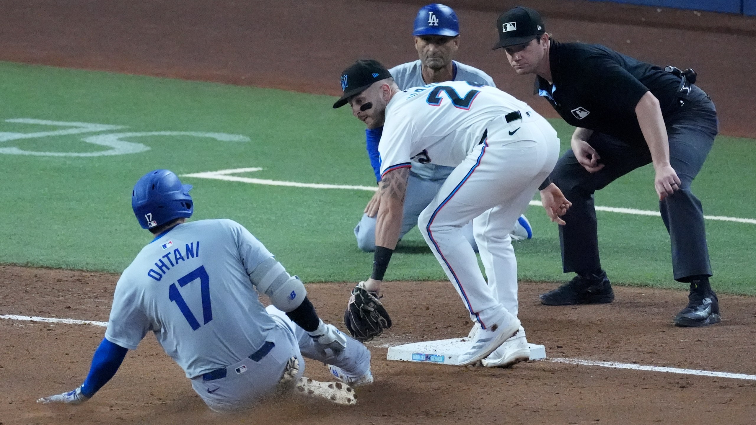 Miami Marlins third baseman Connor Norby tags out Los Angeles Dodgers' Shohei Ohtani (17) of Japan, after Ohtani attempted to stretch out a double during the third inning of a baseball game, Thursday, Sept. 19, 2024, in Miami. (AP Photo/Wilfredo Lee)