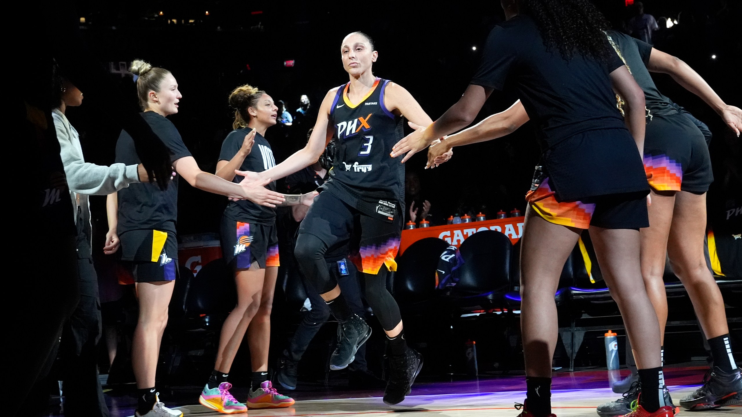 Phoenix Mercury guard Diana Taurasi (3) slaps hands with teammates during player introductions prior to a WNBA basketball game against the Seattle Storm, Thursday, Sept. 19, 2024, in Phoenix. (AP Photo/Ross D. Franklin)