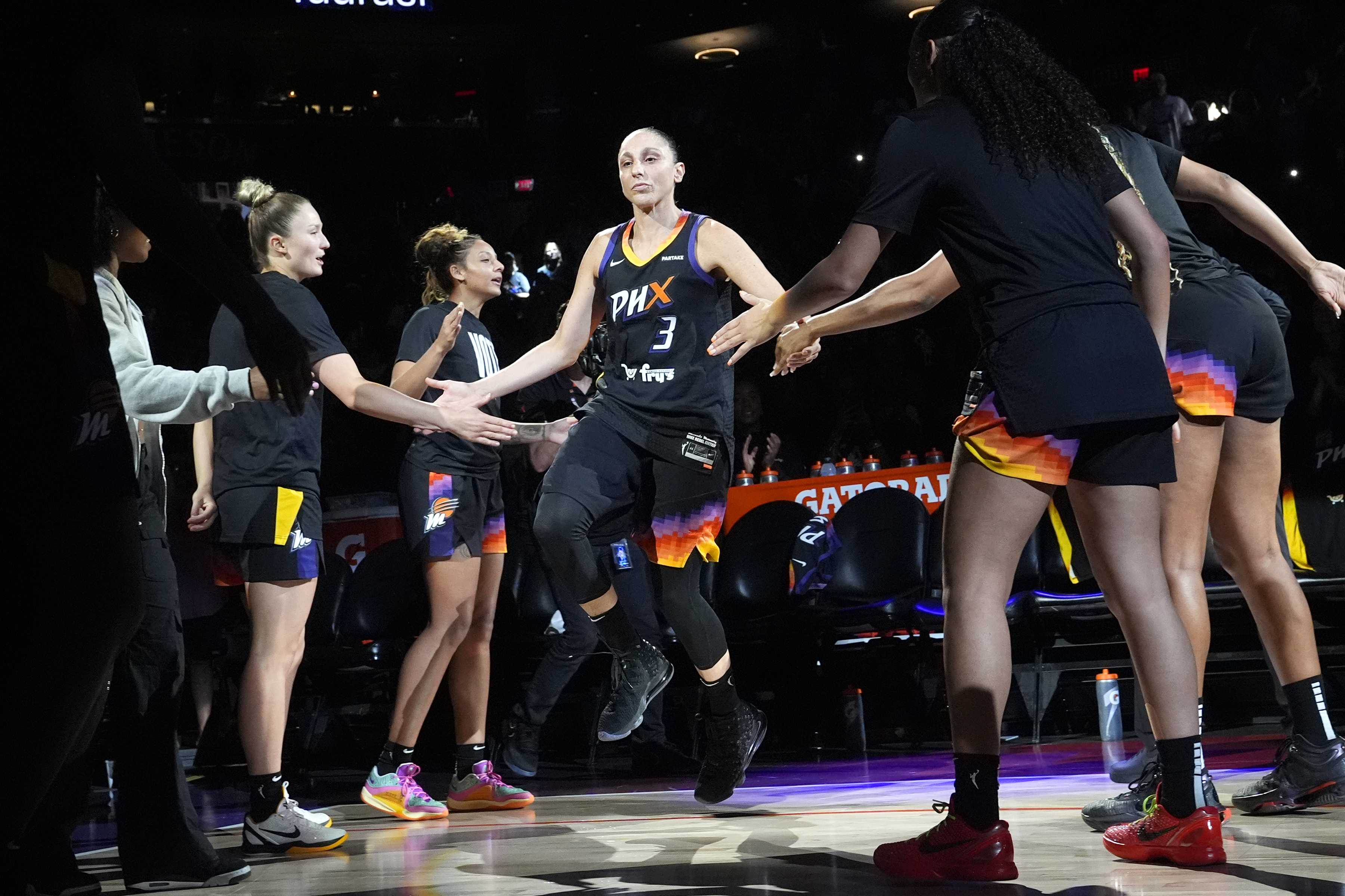 Phoenix Mercury guard Diana Taurasi (3) slaps hands with teammates during player introductions prior to a WNBA basketball game against the Seattle Storm, Thursday, Sept. 19, 2024, in Phoenix. (AP Photo/Ross D. Franklin)