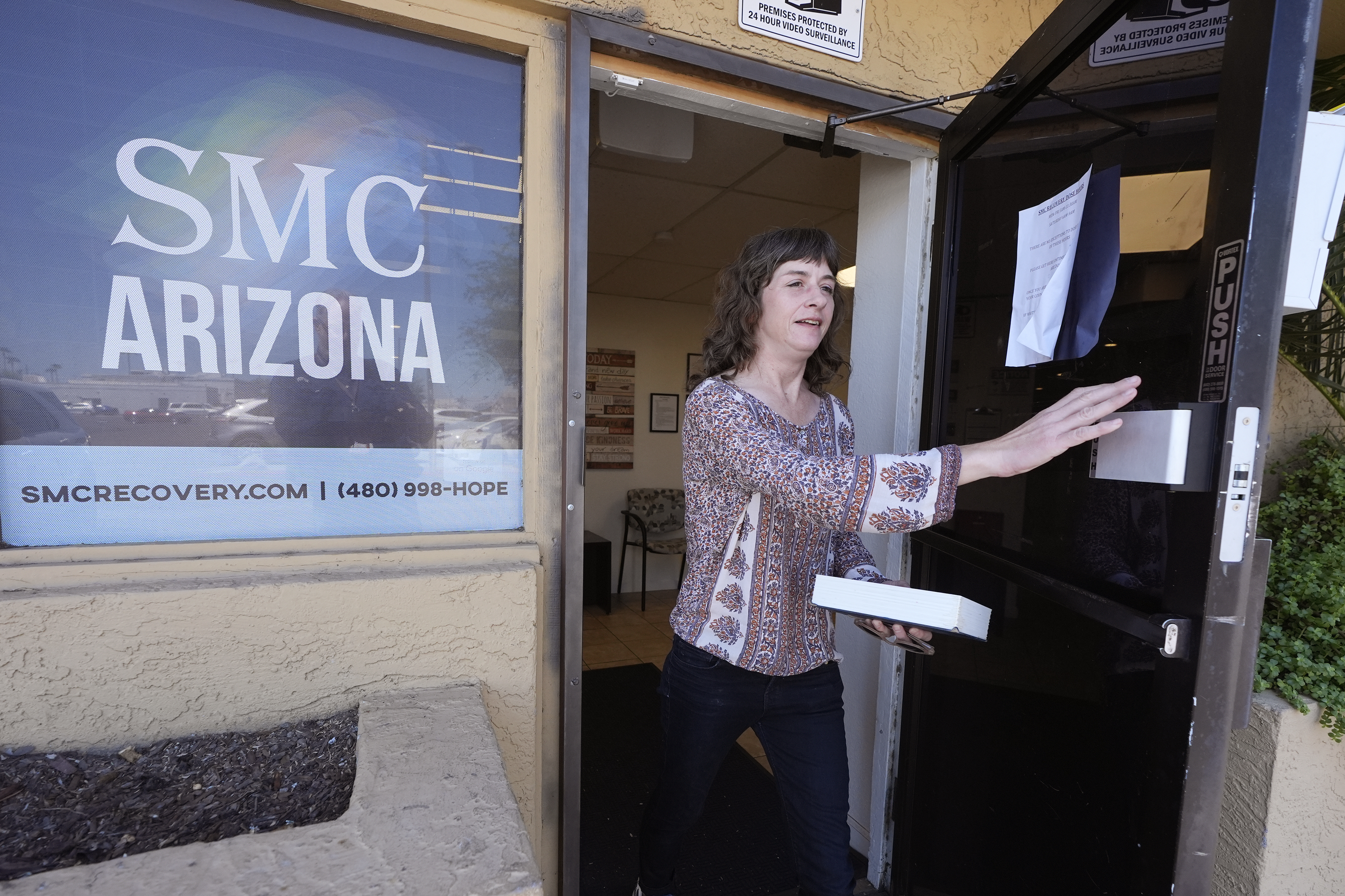 Methadone patient Irene Garnett, 44, of Phoenix, leaves a clinic after taking her medication in Scottsdale, Ariz., on Monday, Aug. 26, 2024. (AP Photo/Ross D. Franklin)