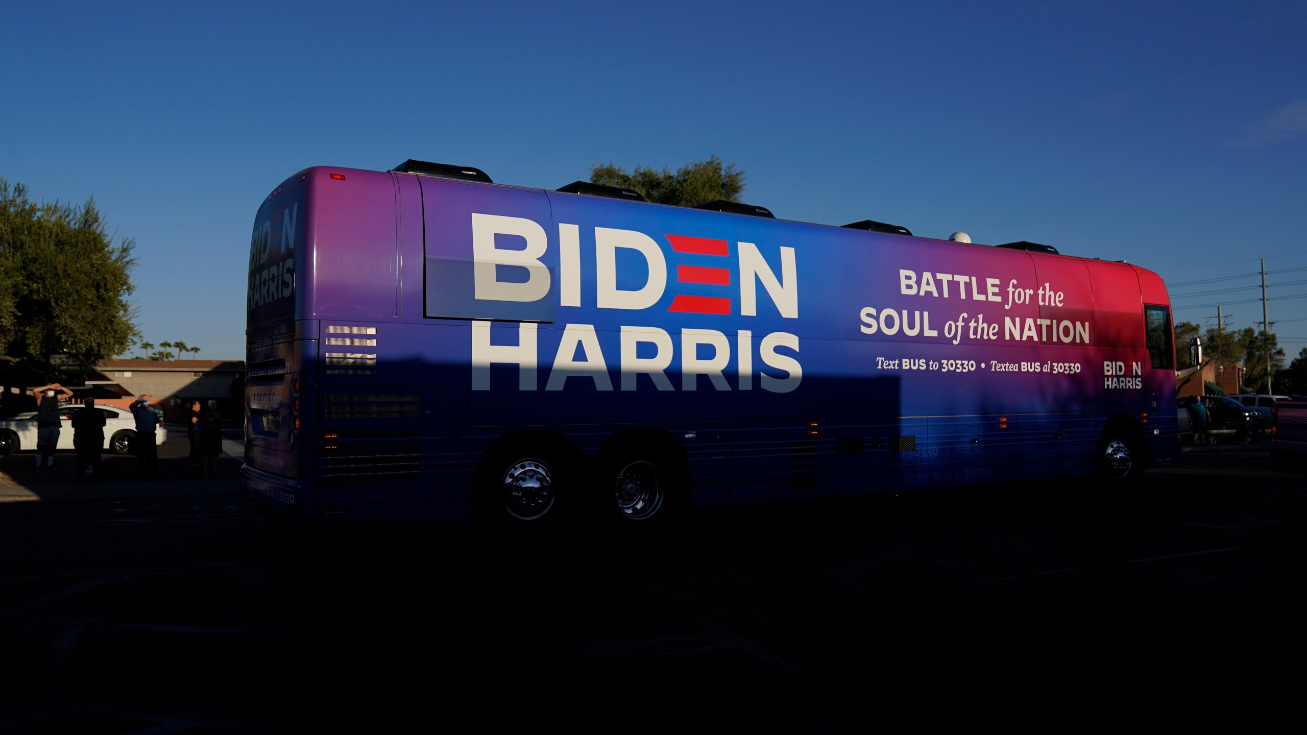 FILE - Democratic presidential candidate former Vice President Joe Biden and Democratic vice presidential candidate Sen. Kamala Harris, D-Calif., ride on a bus in Phoenix, Oct. 8, 2020, on a small business bus tour. (AP Photo/Carolyn Kaster, File)