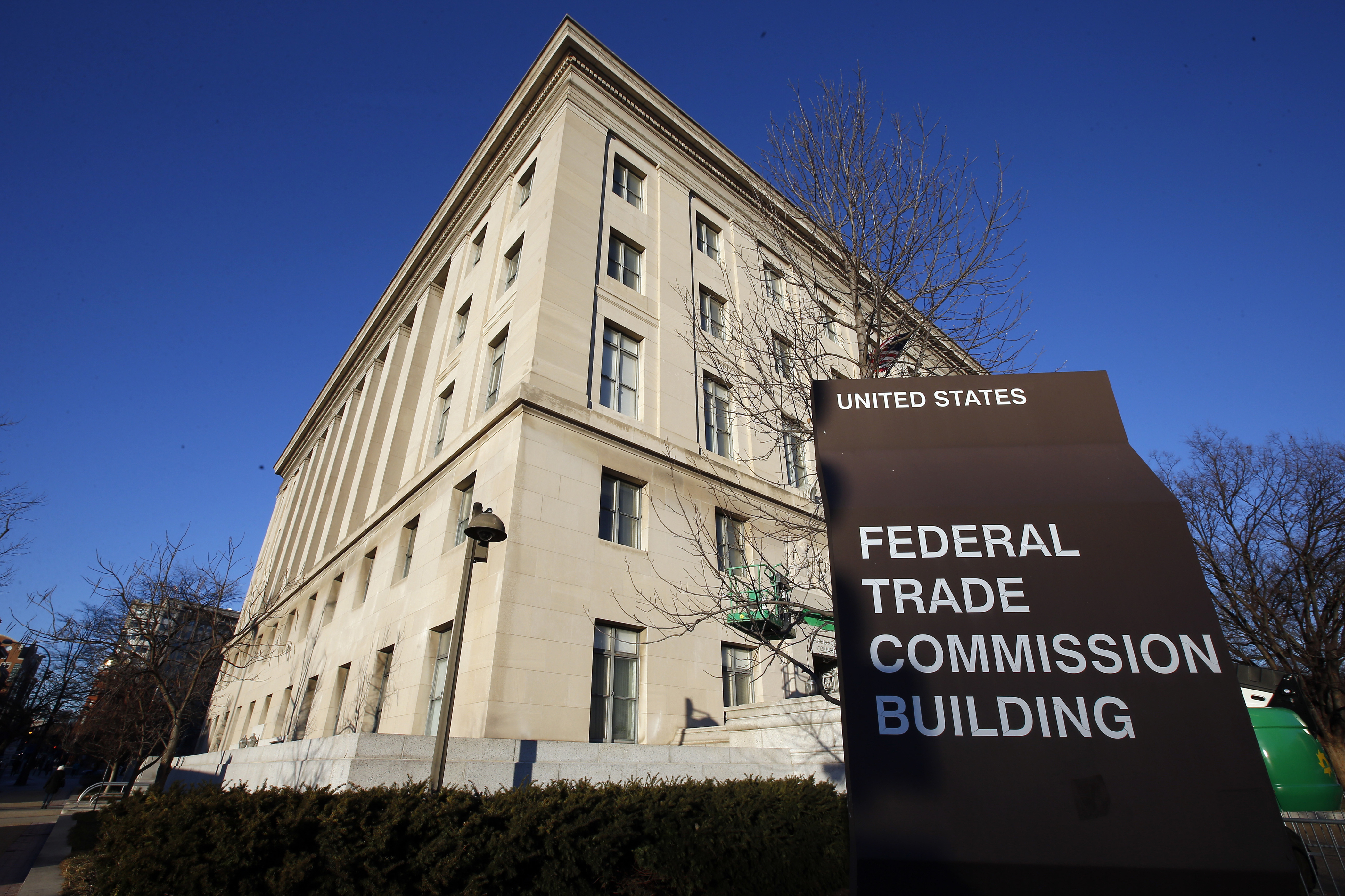 FILE - A sign stands outside the Federal Trade Commission building, Jan. 28, 2015, in Washington. (AP Photo/Alex Brandon, File)