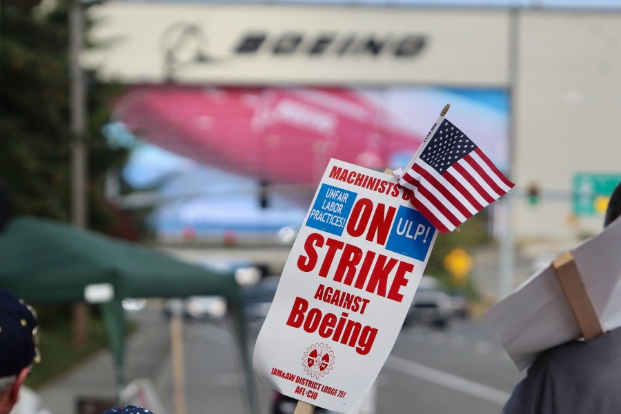 A strike sign is waved on the union machinist picket line near Boeing's factory in Everett, Washington, Thursday, Sept. 19, 2024. (AP Photo/Manuel Valdes)