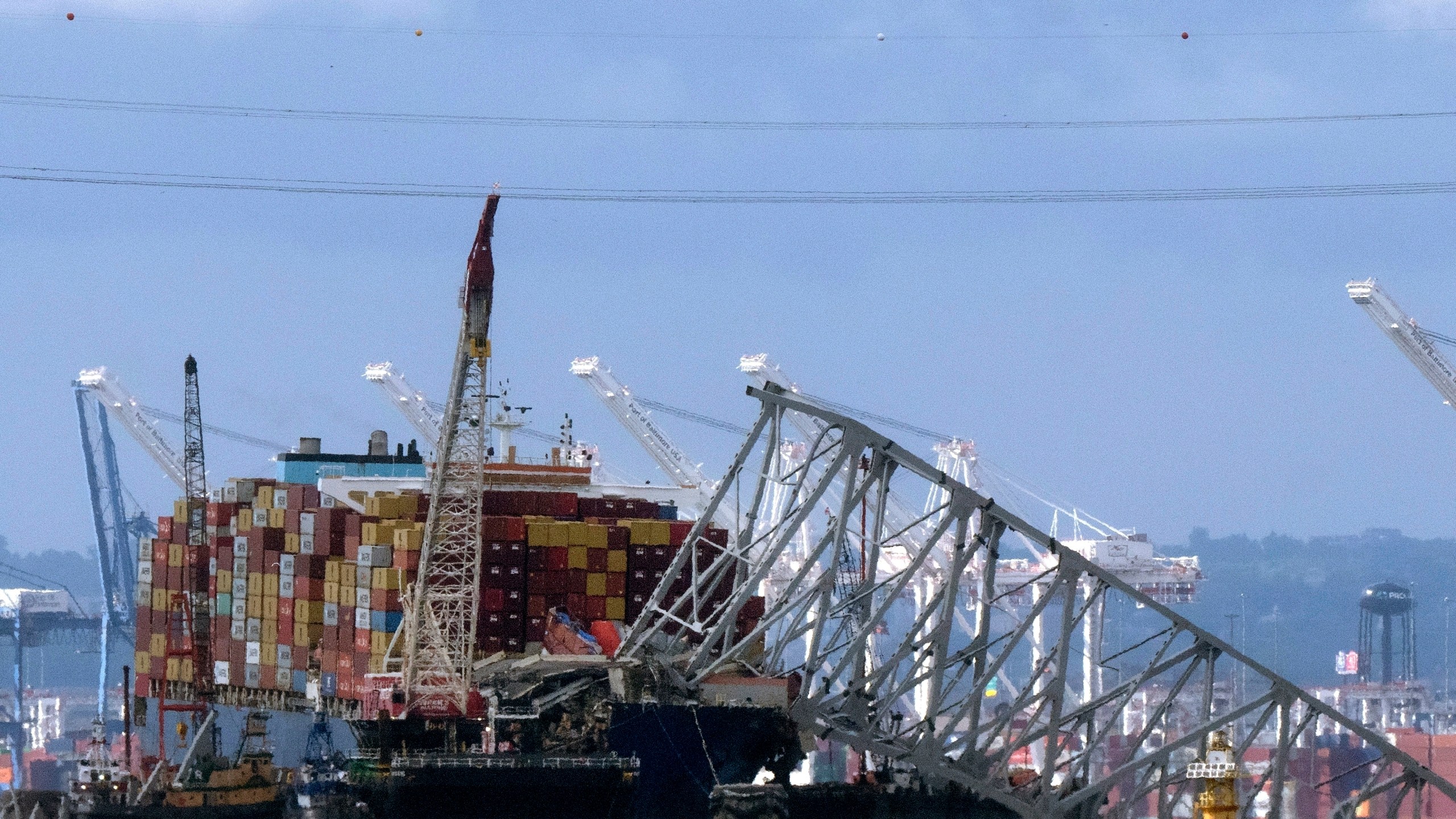 FILE - The collapsed Francis Scott Key Bridge rests on the container ship Dali, May 12, 2024, in Baltimore, as seen from Riviera Beach, Md. (AP Photo/Mark Schiefelbein, File)