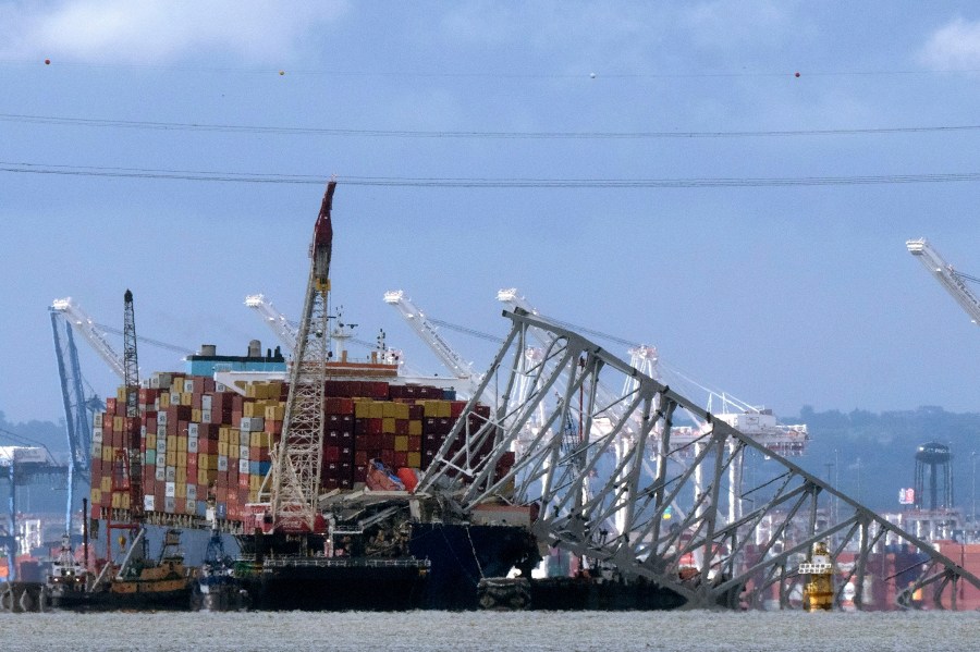 FILE - The collapsed Francis Scott Key Bridge rests on the container ship Dali, May 12, 2024, in Baltimore, as seen from Riviera Beach, Md. (AP Photo/Mark Schiefelbein, File)