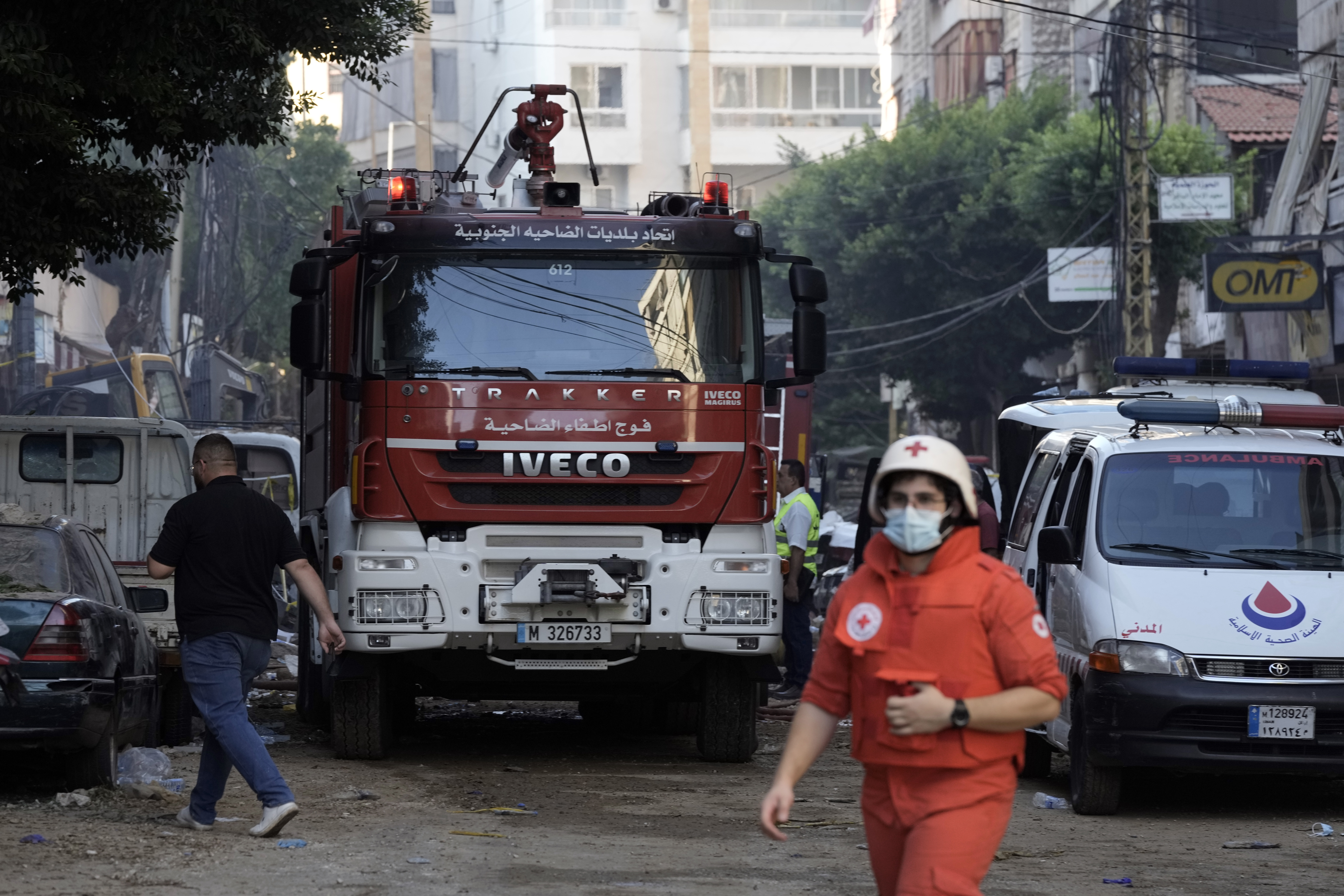 Rescuers at the scene a day after an Israeli missile strike in Beirut's southern suburbs, Saturday, Sept. 21, 2024. (AP Photo/Bilal Hussein)