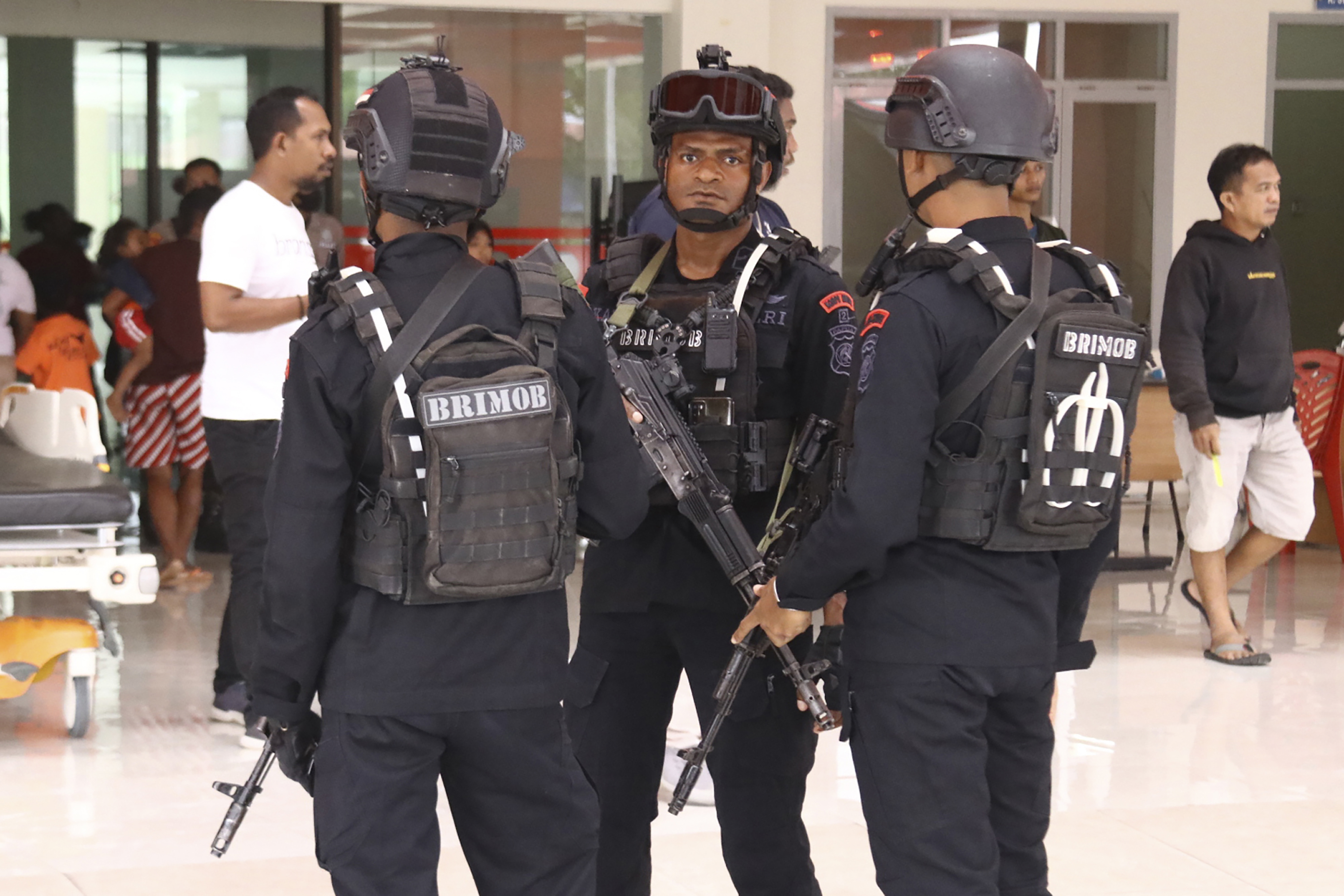 FILE - Police guard a hospital where workers threatened by Papuan rebels were brought for medical examinations in Mimika, Papua province, Indonesia, Wednesday, Feb. 8, 2023. Security forces evacuated the workers from an area where they were searching for a New Zealand pilot taken hostage by separatist rebels of the West Papua Liberation Army. (AP Photo/Saldi Hermanto, File)