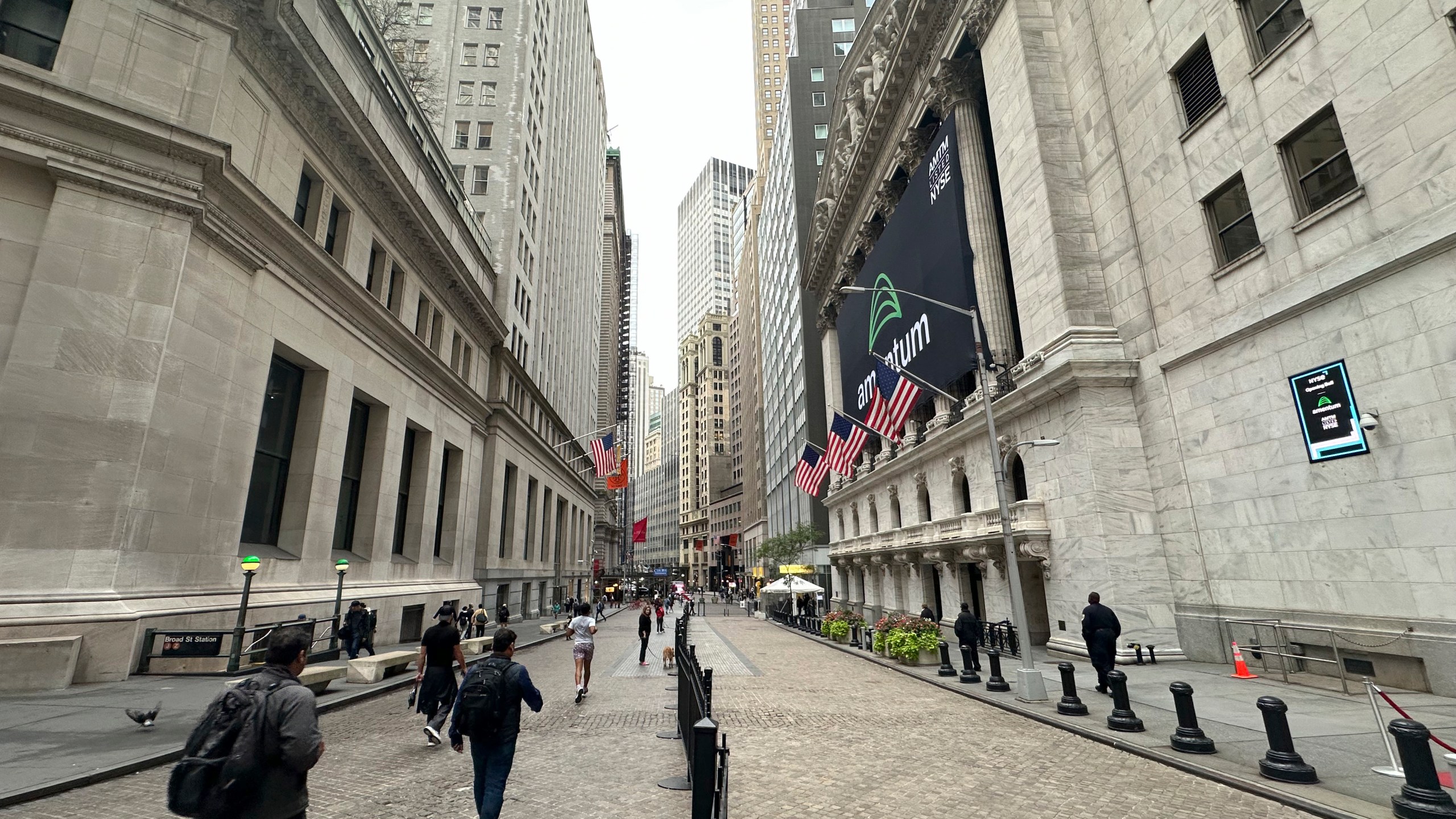 The New York Stock Exchange, right, is shown on Tuesday, Oct. 1, 2024, in New York. (AP Photo/Peter Morgan)