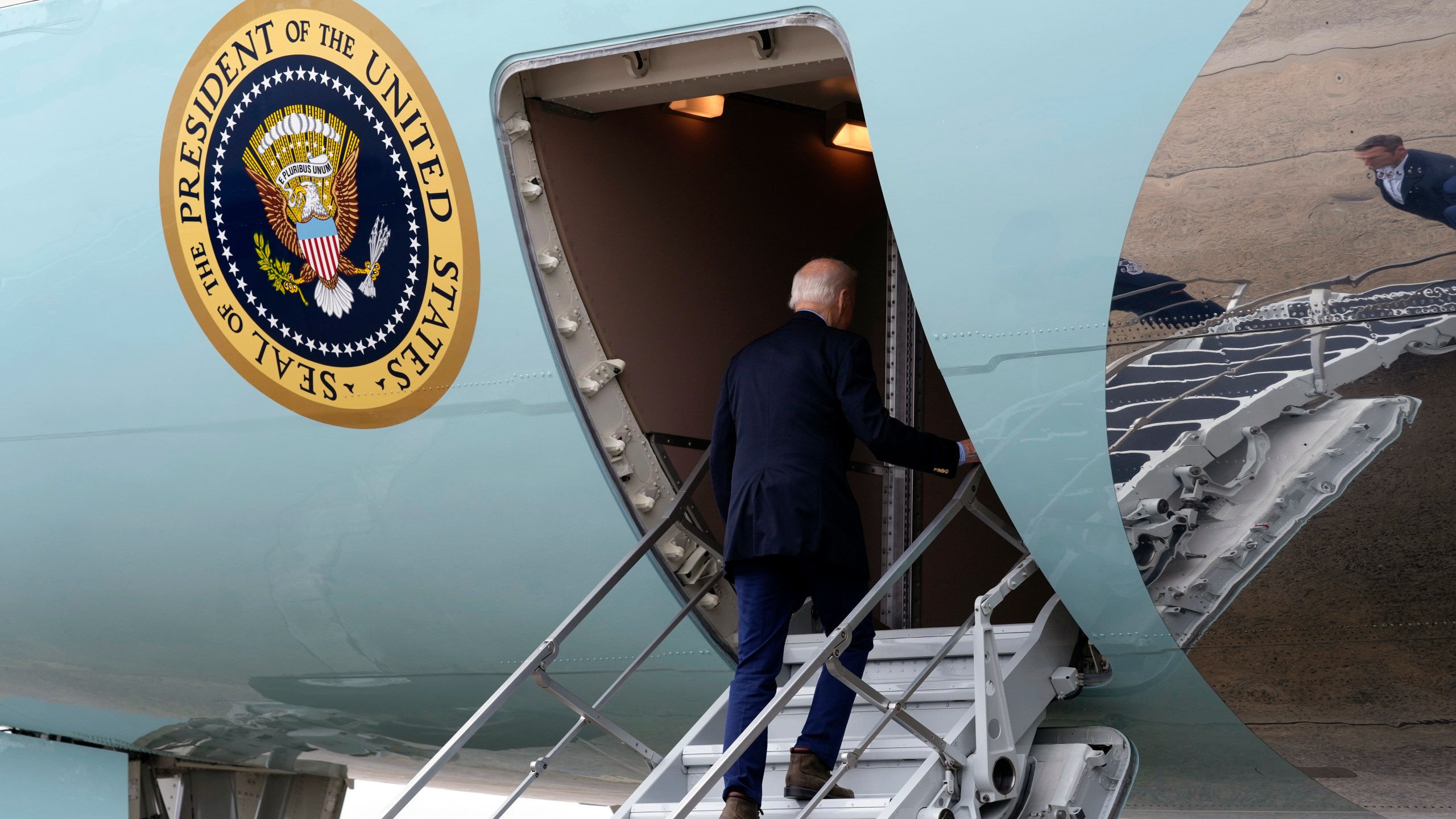 President Joe Biden walks up the steps and boards Air Force One at Joint Base Andrews, Md., Wednesday, Oct. 2, 2024, as he heads to North and South Carolina to survey damage from Hurricane Helene. (AP Photo/Susan Walsh)