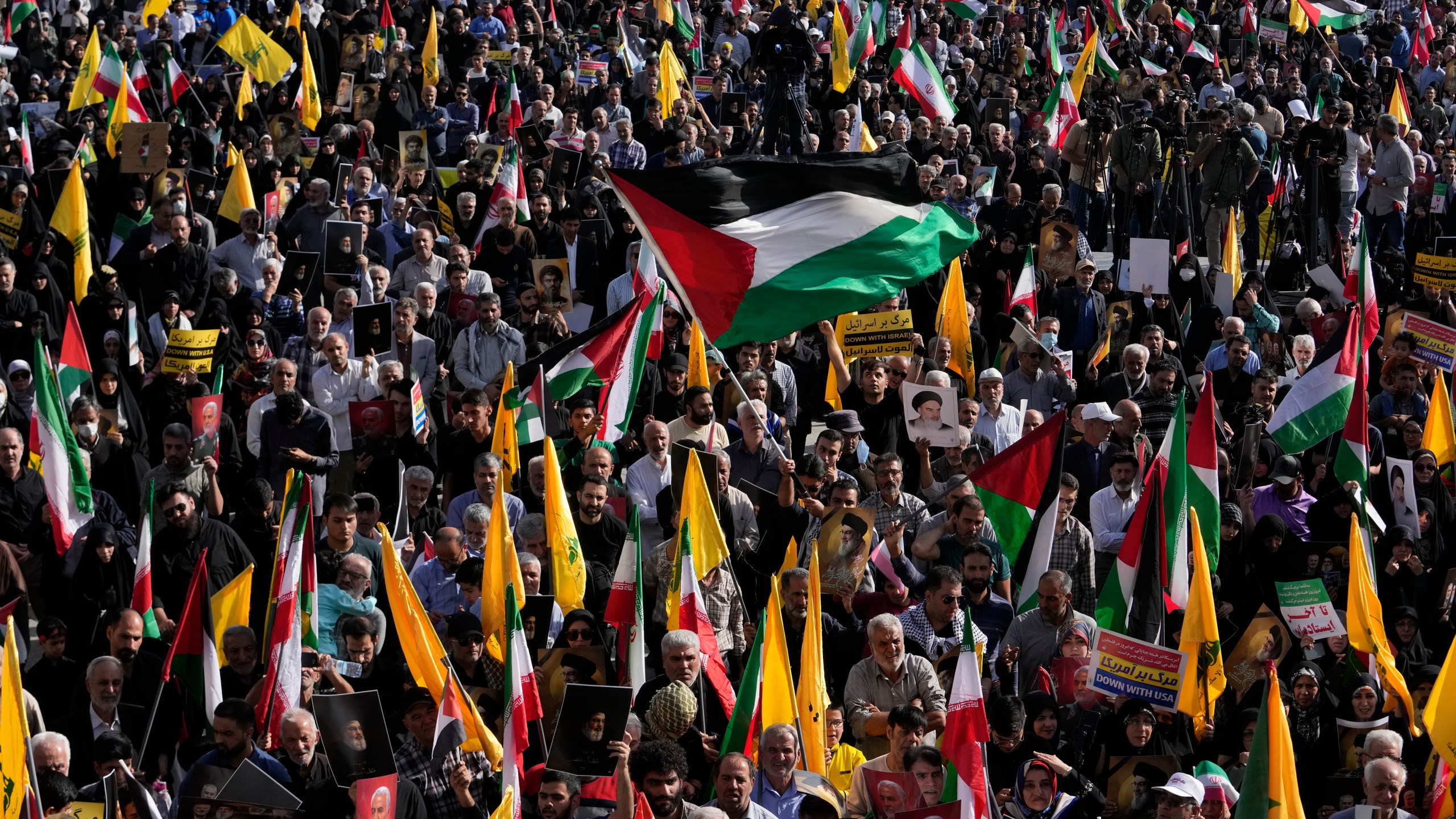 A demonstrator waves a Palestinian flag at a rally commemorating slain Hezbollah leader Hassan Nasrallah, in Tehran, Iran, Wednesday, Oct. 2, 2024. (AP Photo/Vahid Salemi)