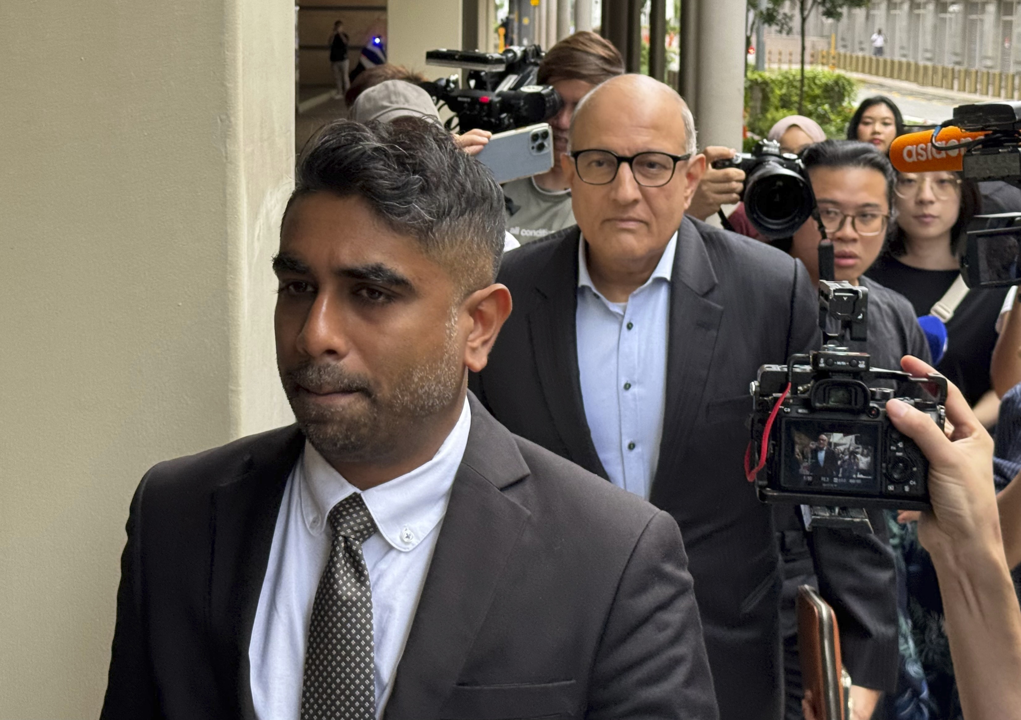 Former Transport Minister S. Iswaran, left, and his lawyer Mr. Navin Thevar arrive at the High Court in Singapore, July 5, 2024. (AP Photo)