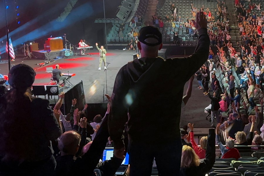 Audience members raise their hands in agreement with speaker Samuel Rodriguez, lead pastor of New Season church in Sacramento, Calif., at the Opening the Heavens conference on Friday, Sept. 13, 2024, at the Mid-America Center in Council Bluffs, Iowa. (AP Photo/Peter Smith)