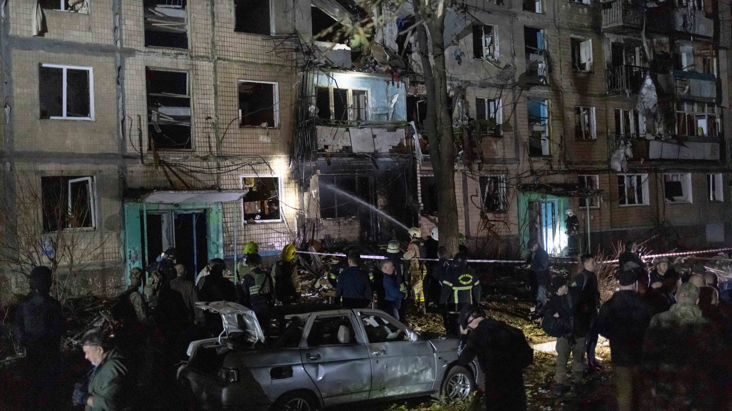 Rescue workers clear the rubble of a building damaged by a Russian airstrike in Kharkiv, Ukraine, Wednesday Oct. 2, 2024. (AP Photo/Yevhen Titov)