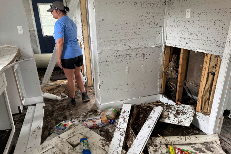 Brooke Hiers surveys the damage done to her home, Monday, Sept. 30, 2024, in Horseshoe Beach, Fla., in the aftermath of Hurricane Helene. Hiers and her husband rebuilt the home in the wake of Hurricane Idalia, which washed ashore in August, 2023, only to see it destroyed by another storm 13 months later. (AP Photo/Kate Payne)