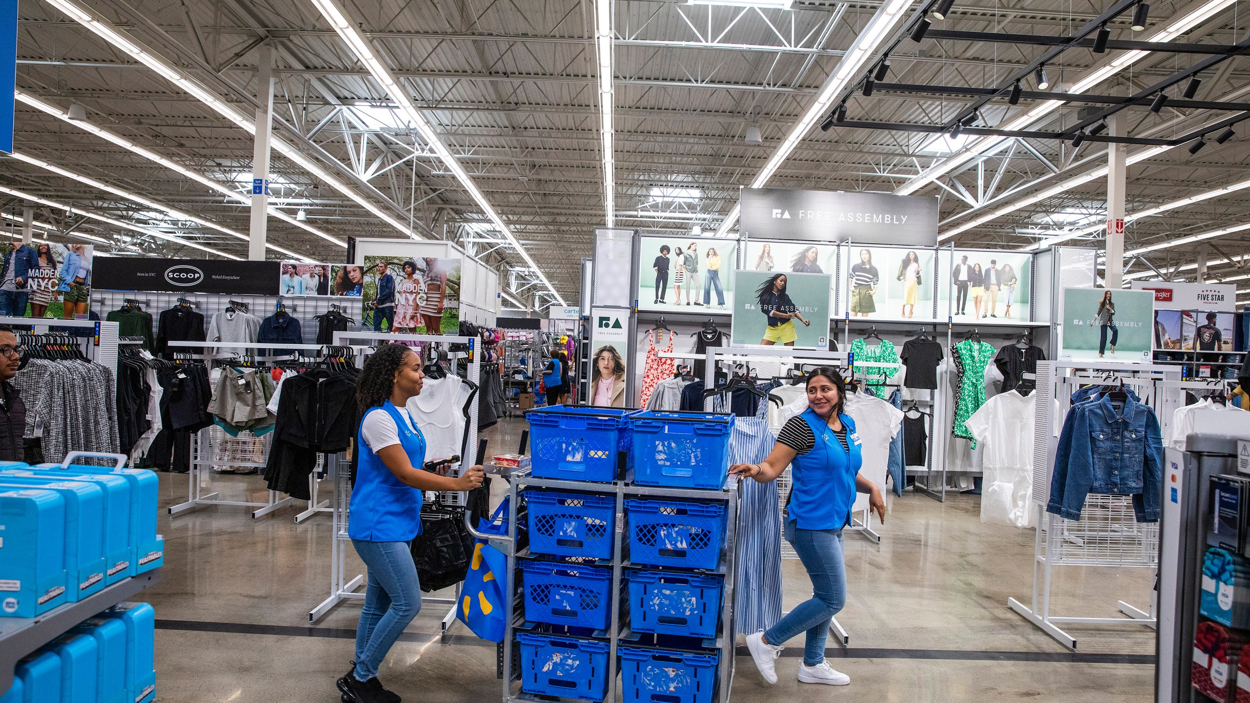 FILE - Walmart workers organize merchandise at a Superstore in Secaucus, New Jersey, July 11, 2024. (AP Photo/Eduardo Munoz Alvarez, File)