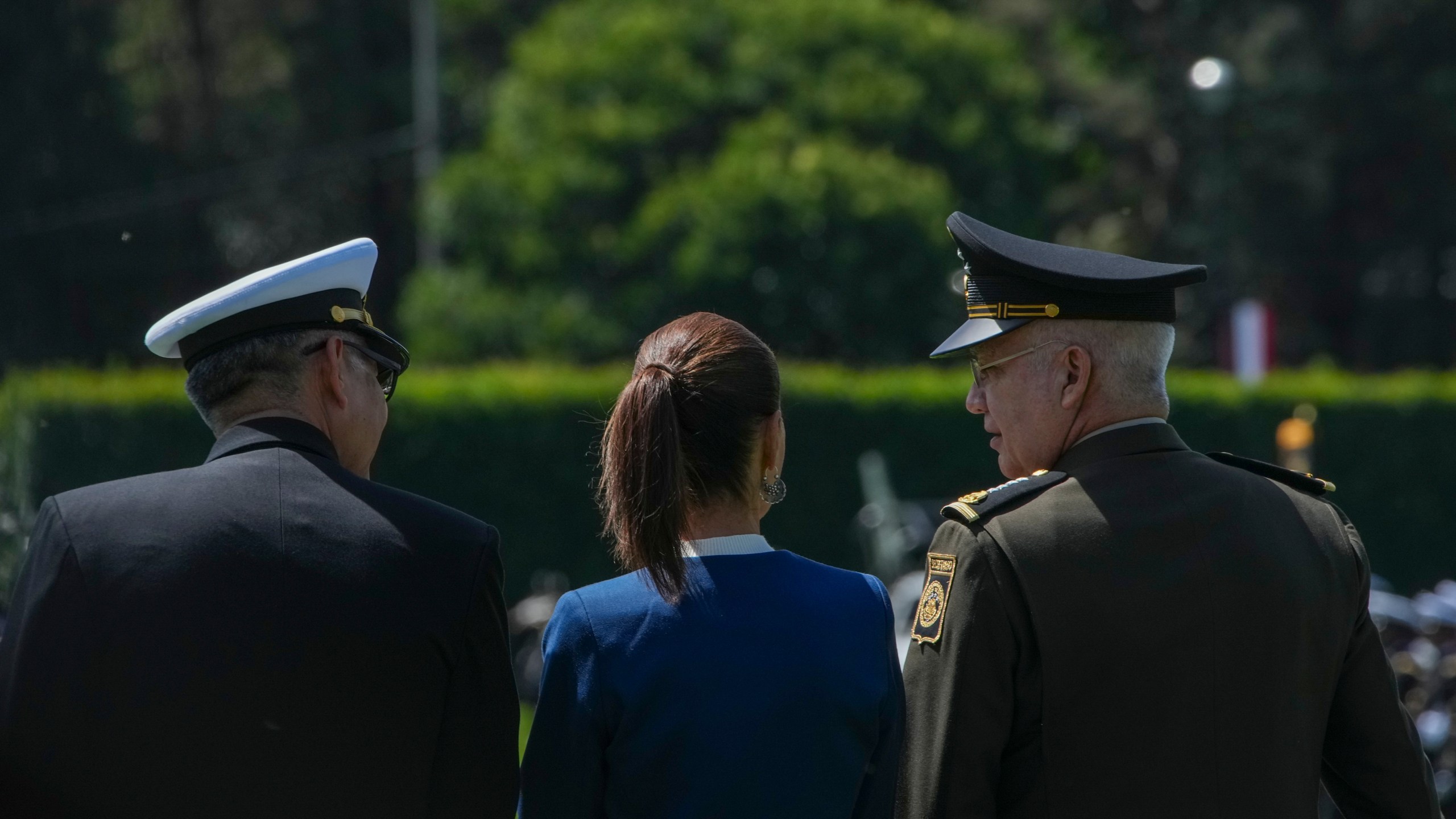 Mexican President Claudia Sheinbaum, center, reviews the troops with Defense Minister Gen. Ricardo Trevilla Trejo, right, and Navy Secretary Alt. Raymundo Pedro Morales at Campo Marte in Mexico City, Thursday, Oct. 3, 2024. (AP Photo/Fernando Llano)