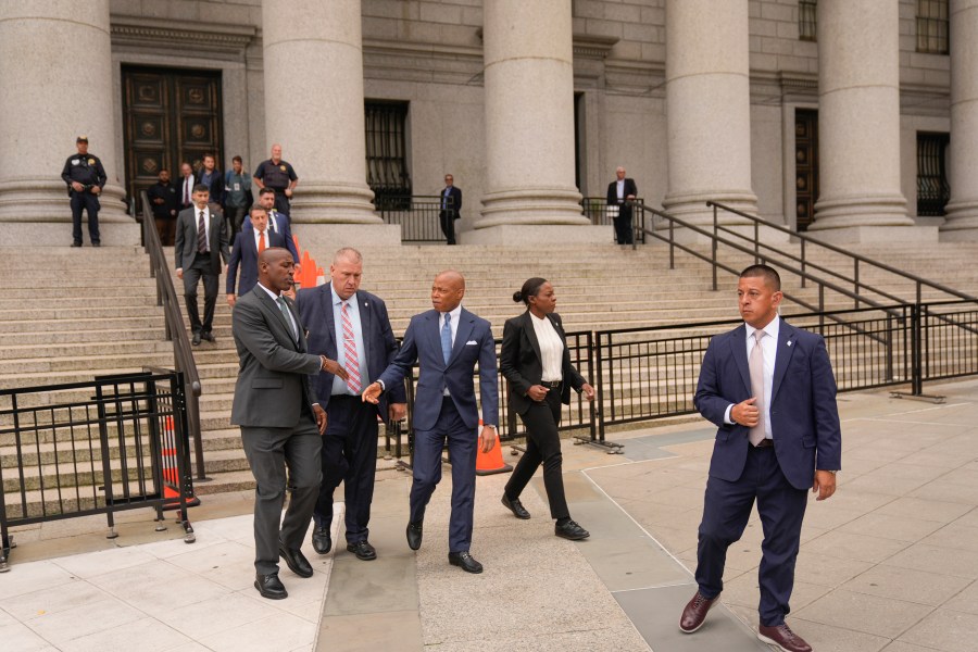 New York City Mayor Eric Adams, center, leaves the courthouse in New York, Wednesday, Oct. 2, 2024. (AP Photo/Seth Wenig)