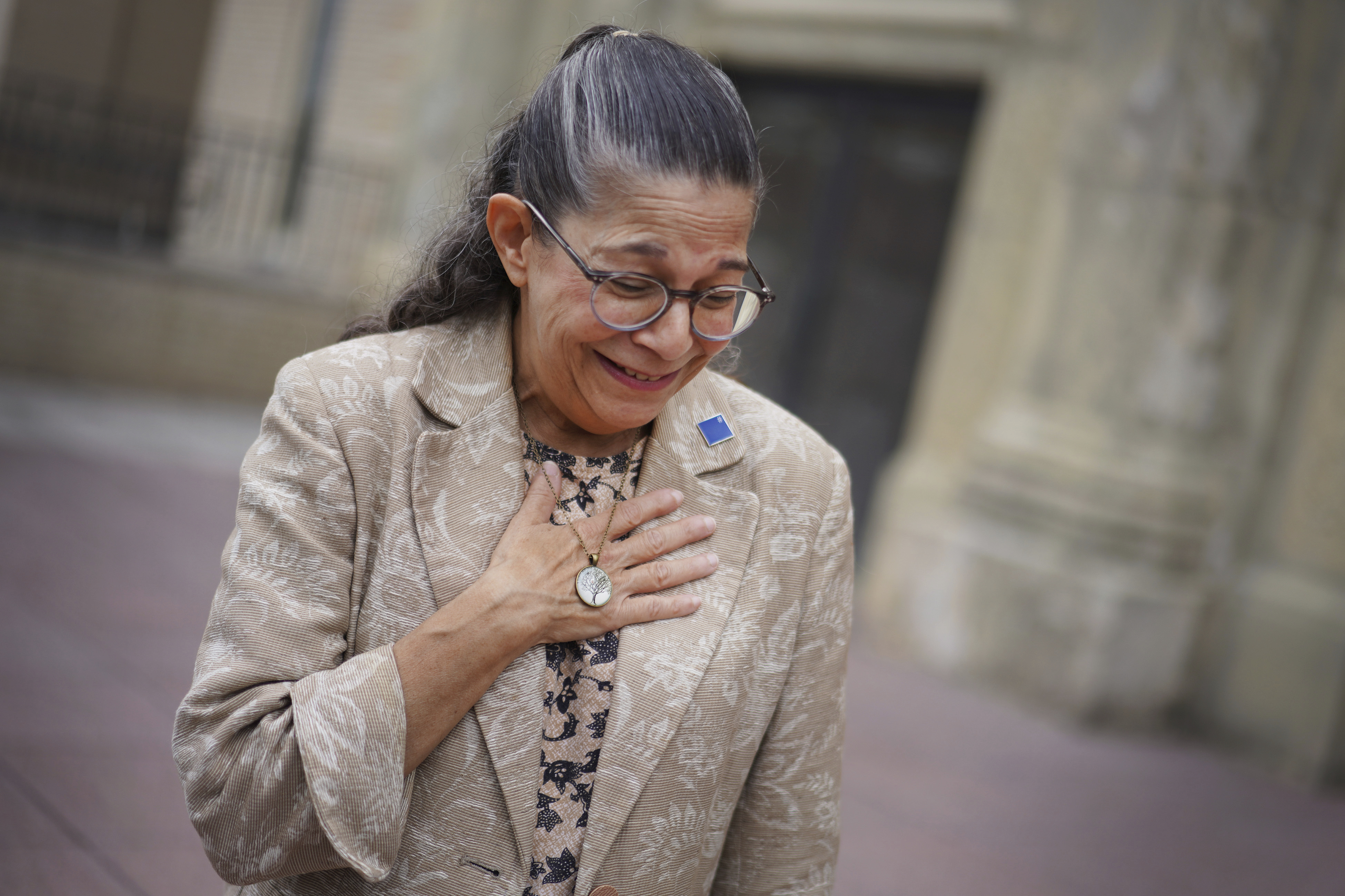 Audrey Glickman, a Tree of Life member who survived the 2018 attack, holds a necklace representing the synagogue, Friday, Sept. 27, 2024, in Pittsburgh. (AP Photo/Jessie Wardarski)