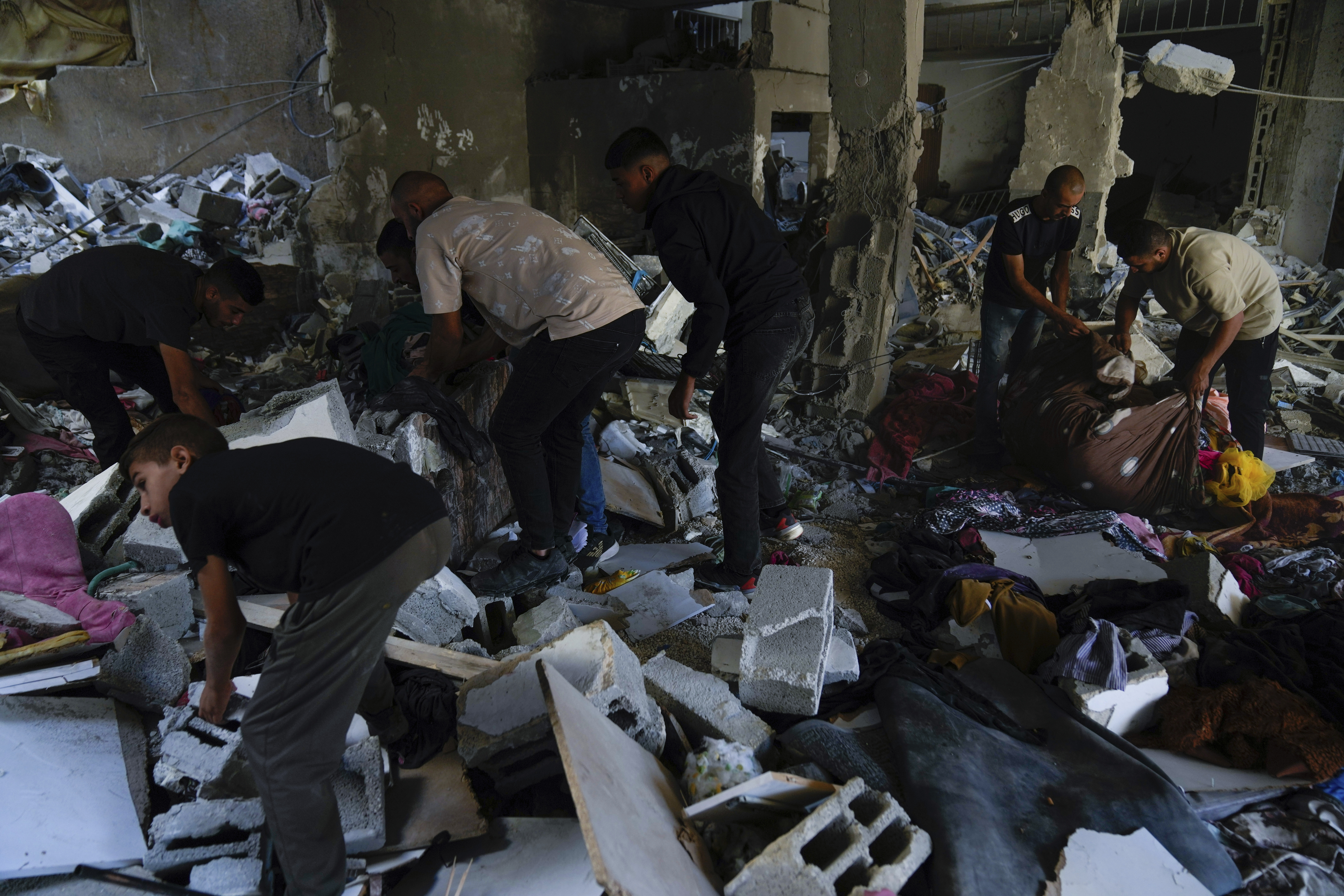 Palestinians examine the damage following an Israeli airstrike in the West Bank city of Tulkarem, which Palestinian health officials say killed 18 people and the Israeli military says took out a Hamas leader, on Friday, Oct. 4, 2024. (AP Photo/Nasser Nasser)