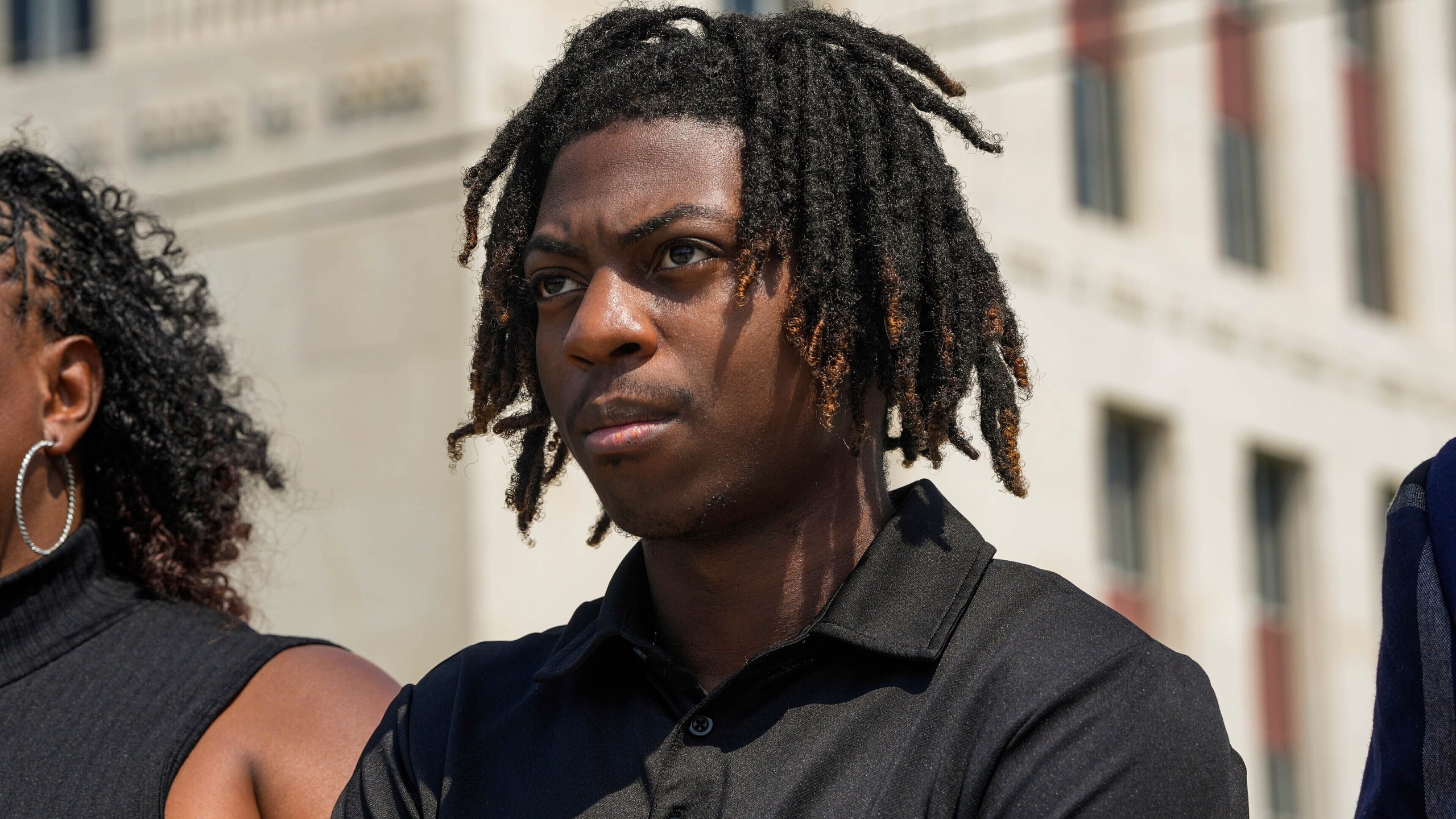 FILE - Darryl George stands next to his mother, Darresha George, in front of Galveston County Court House, May 23, 2024, in Galveston, Texas. A federal judge on Friday, Oct. 4, 2024 denied a request by Darryl George, a Black high school student in Texas for a court order that the student’s lawyers say would have allowed him to return to his high school without fear of having his previous punishment over his hairstyle resume.(Raquel Natalicchio/Houston Chronicle via AP, File)