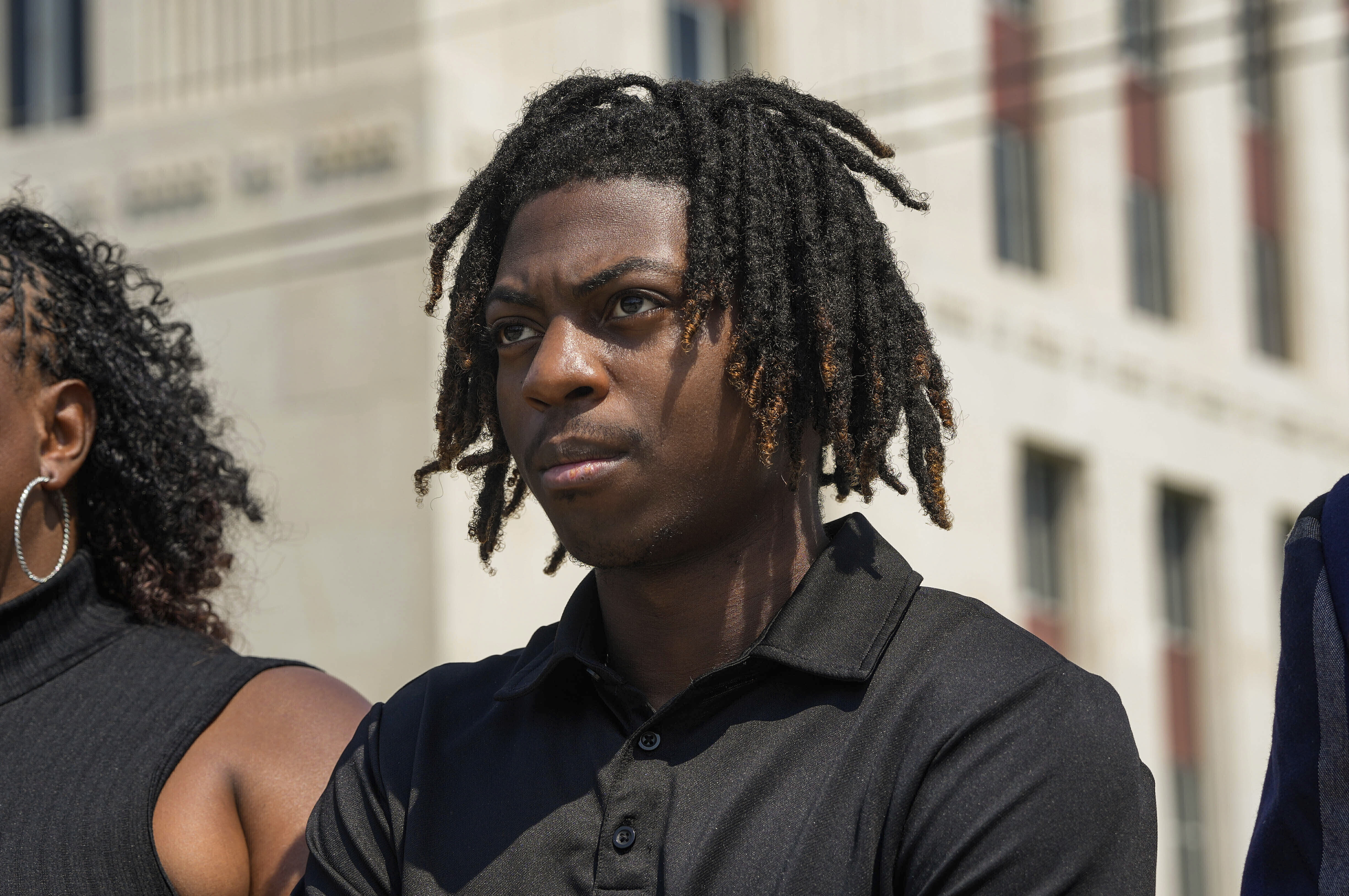 FILE - Darryl George stands next to his mother, Darresha George, in front of Galveston County Court House, May 23, 2024, in Galveston, Texas. A federal judge on Friday, Oct. 4, 2024 denied a request by Darryl George, a Black high school student in Texas for a court order that the student’s lawyers say would have allowed him to return to his high school without fear of having his previous punishment over his hairstyle resume.(Raquel Natalicchio/Houston Chronicle via AP, File)