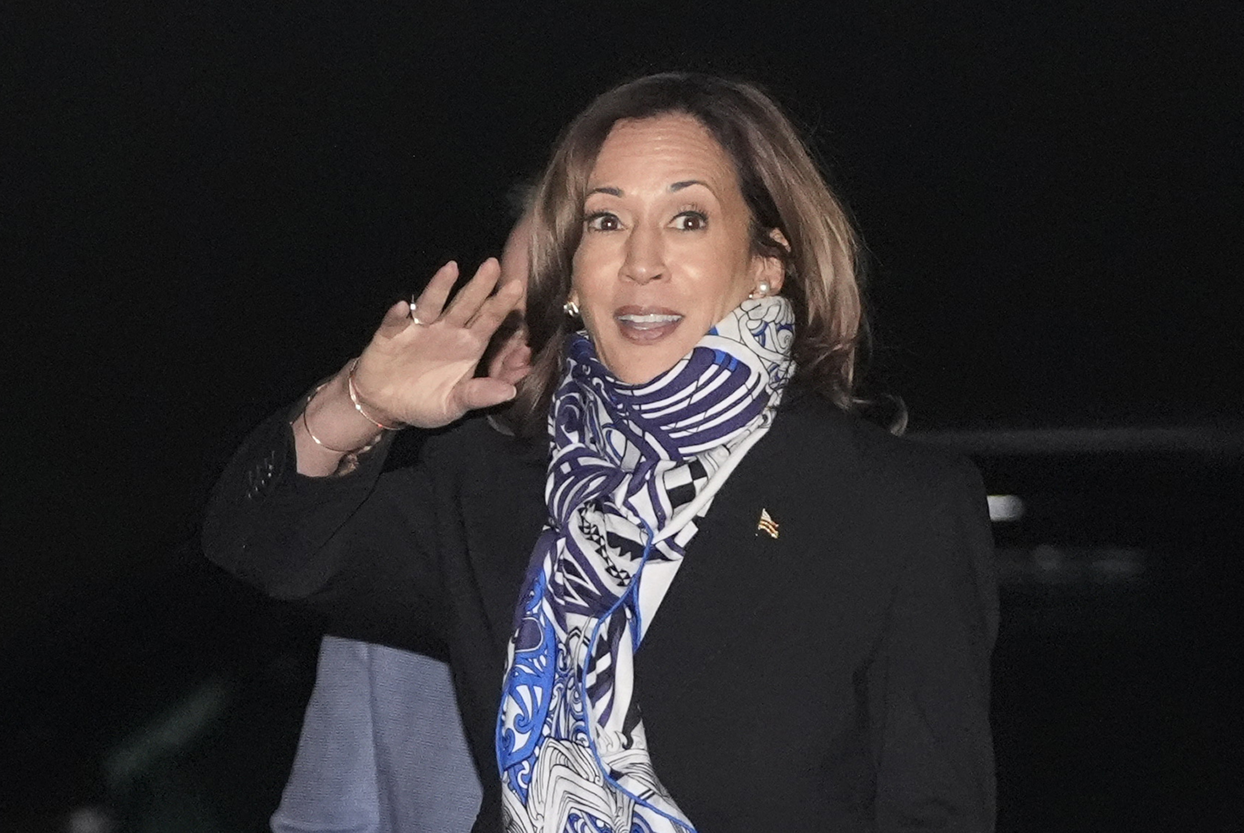 Democratic presidential nominee Vice President Kamala Harris waves as she arrives on Air Force Two at Detroit Metropolitan Wayne County Airport in Romulus, Mich., Thursday, Oct. 3, 2024. (AP Photo/Mark Schiefelbein)