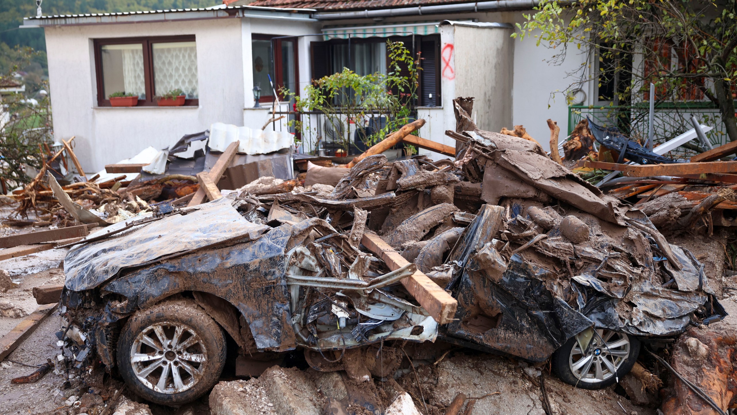 A damaged car is seen after flood hit the village of Donja Jablanica, Bosnia, Saturday, Oct. 5, 2024. (AP Photo/Armin Durgut)