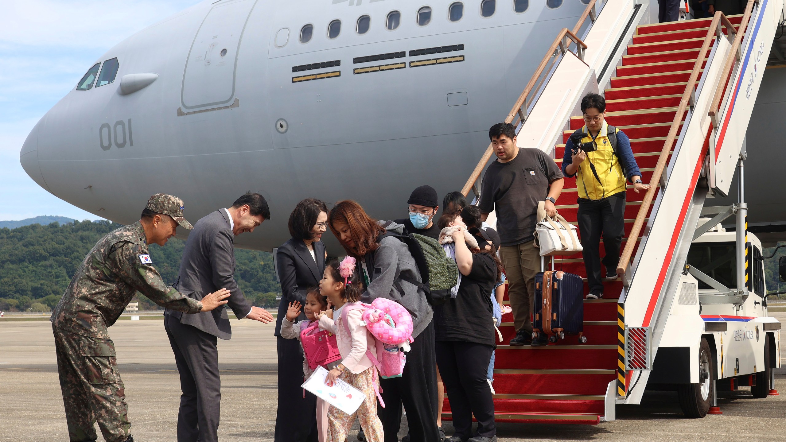 South Korean nationals and their family members arrive after being evacuated from Lebanon with a South Korea's military aircraft at the Seoul airport in Seongnam, South Korea, Saturday, Oct. 5, 2024. (Korea Pool/Yonhap via AP)