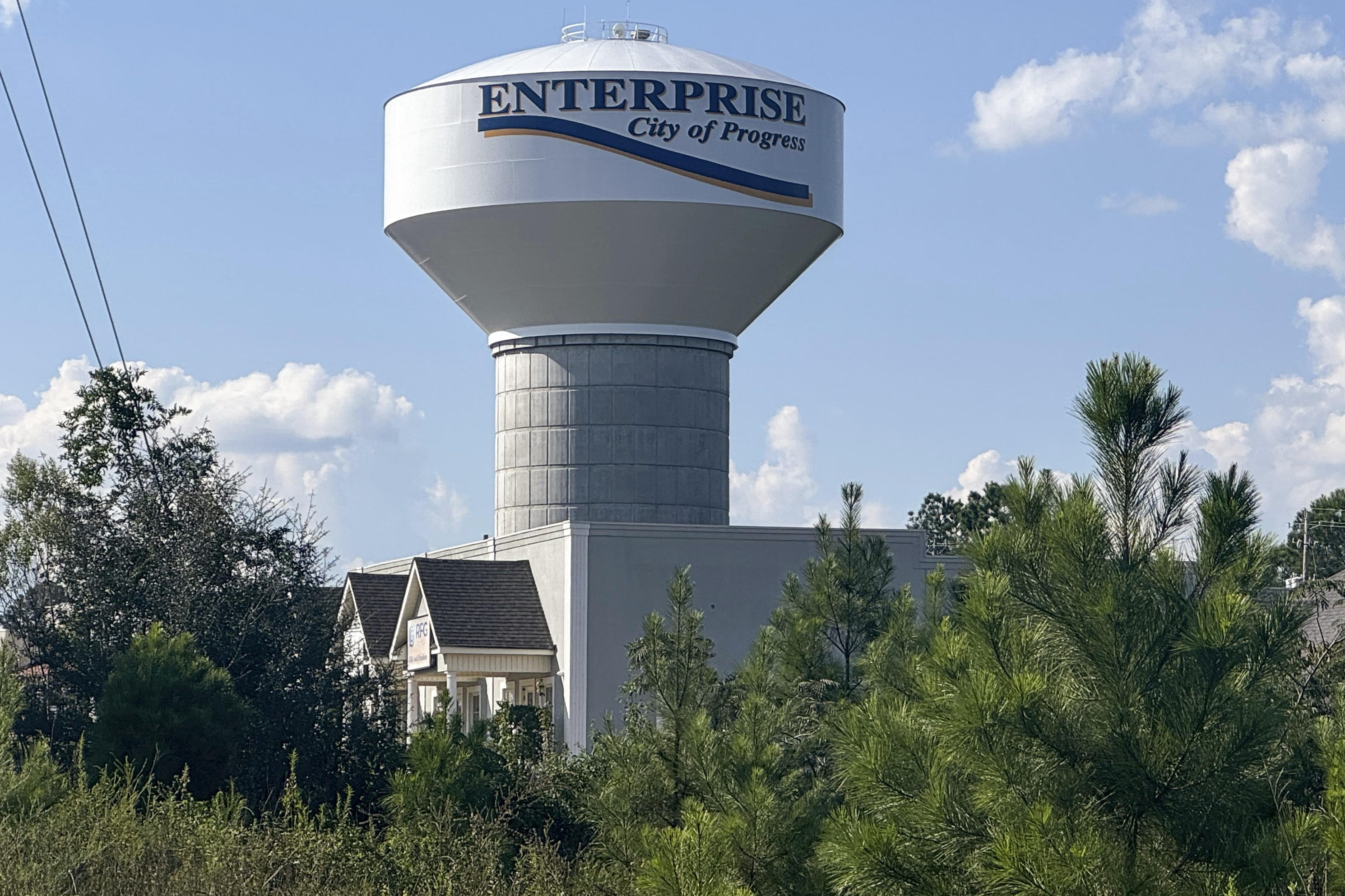 A water tower welcoming drivers into the town of Enterprise, Ala., with the words, "City of Progress," is seen, Sept. 19, 2024. (AP Photo/Safiyah Riddle)