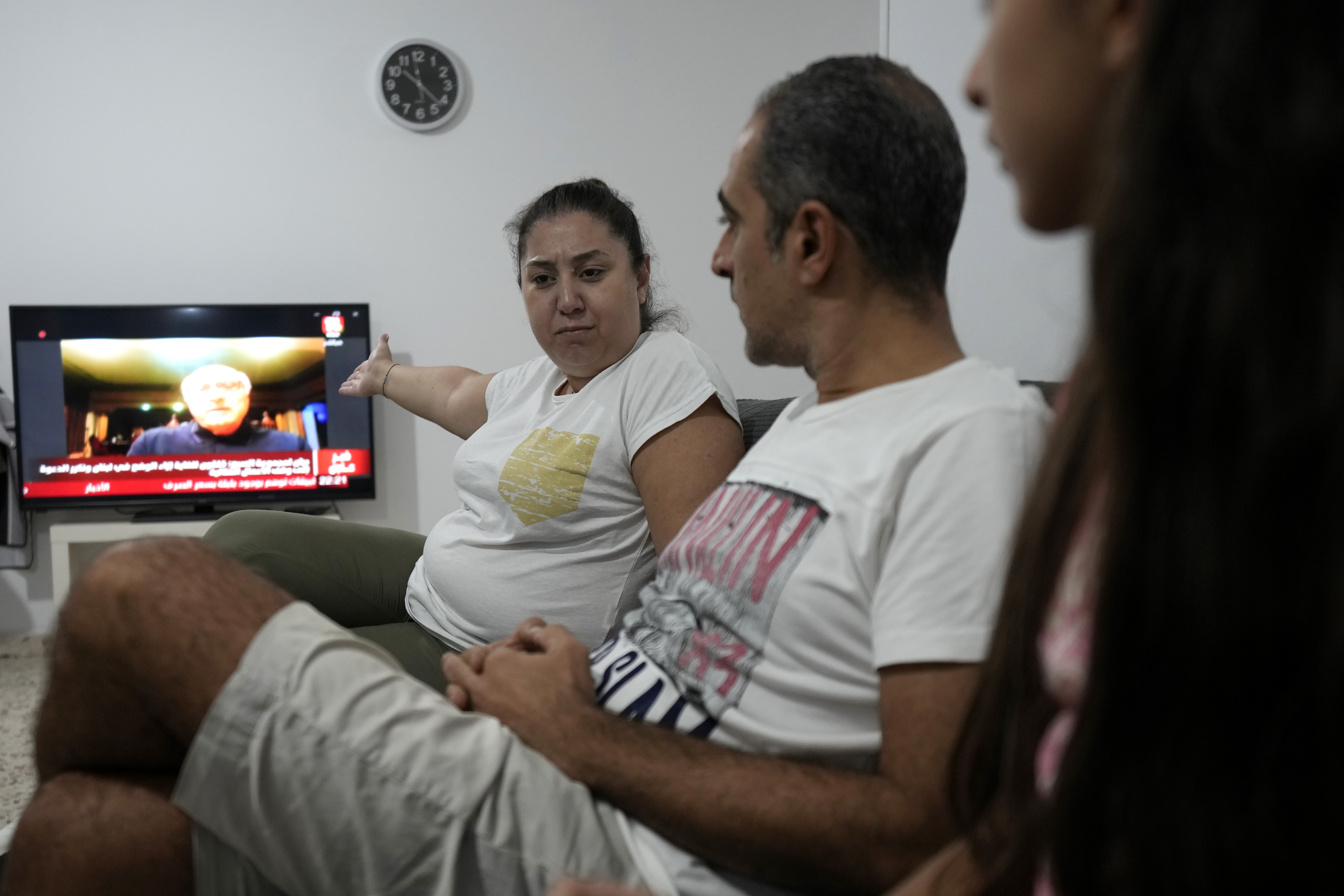 Rosaline Ghoukassian, left; her husband, Raffi Garabedian, center, and their daughter, Maria, who relocated to Cyprus after the 2020 ammonium nitrate explosion in Beirut's port, sit in the living room of their rented apartment in Nicosia, Cyprus, Thursday, Oct. 3, 2024. (AP Photo/Petros Karadjias)