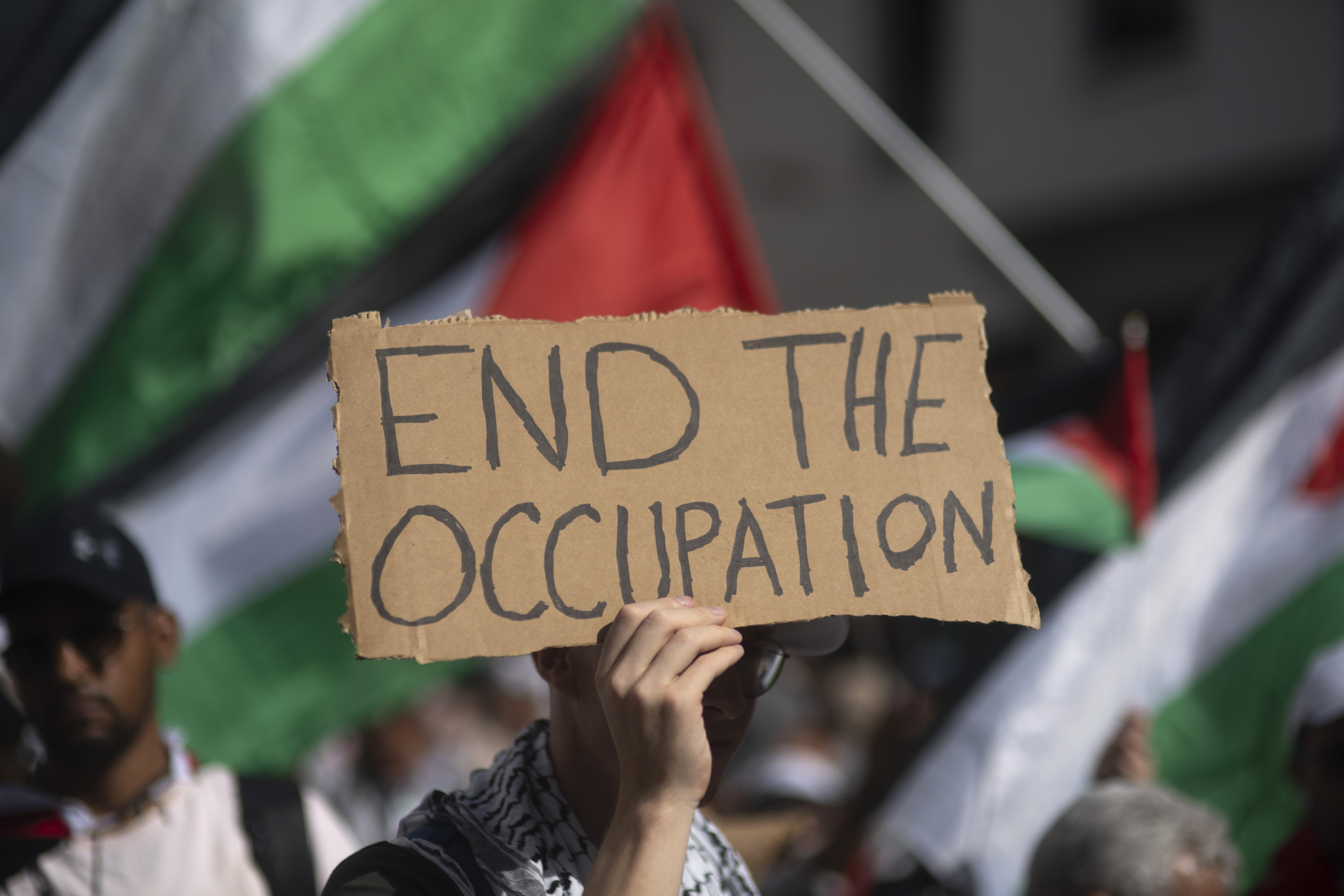 A Moroccan man carries a sign during a protest in support of Gaza and Lebanon, in Rabat, Morocco, Sunday, Oct. 6, 2024 (AP Photo/Mosa'ab Elshamy)