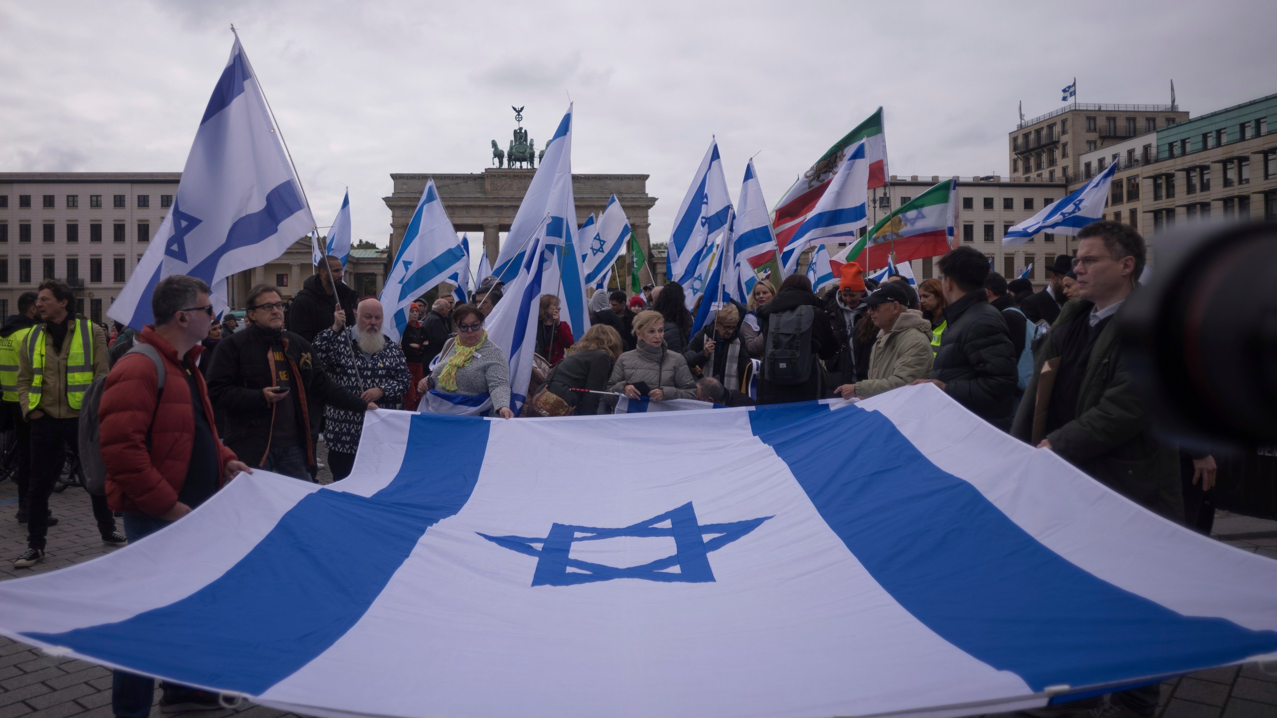 People attend a demonstration in support of Israel to mark the first anniversary of the Hamas attack on Israel, at the Brandenburg Gate in Berlin, Germany, Sunday, Oct. 6, 2024. (AP Photo/Markus Schreiber)