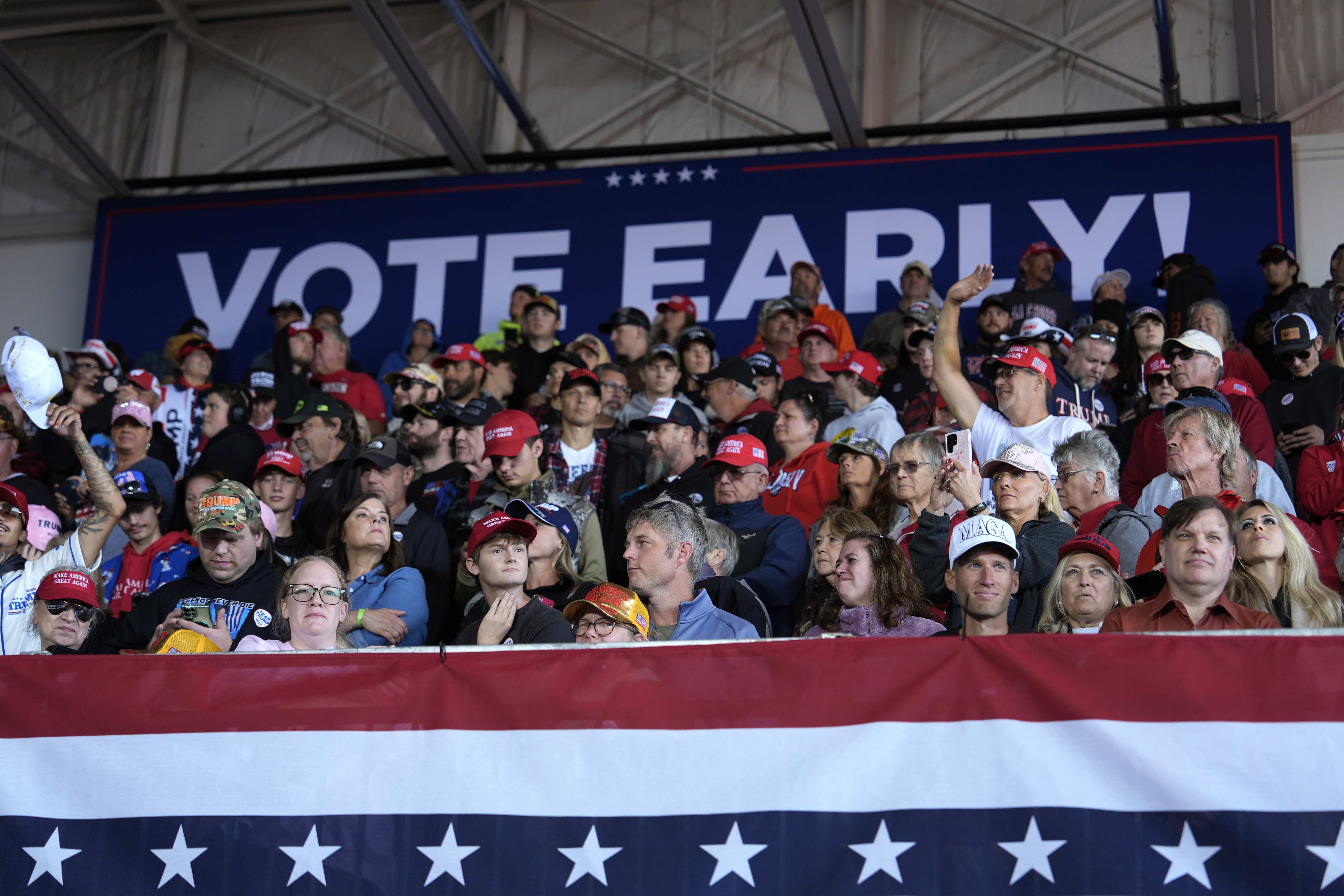 Attendees wait for Republican presidential nominee former President Donald Trump to speak during a campaign rally at Dodge County Airport, Sunday, Oct. 6, 2024, in Juneau, Wis. (AP Photo/Julia Demaree Nikhinson)