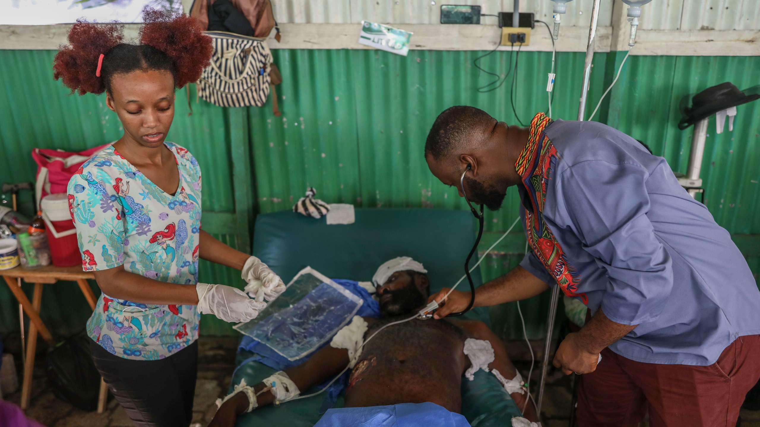 Doctors treat a man who was shot and wounded during armed gang attacks, at Saint Nicolas hospital in Saint-Marc, Haiti, Sunday, Oct. 6, 2024. (AP Photo/Odelyn Joseph)