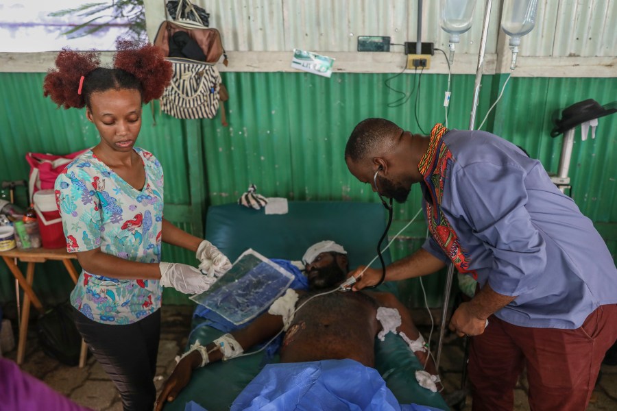 Doctors treat a man who was shot and wounded during armed gang attacks, at Saint Nicolas hospital in Saint-Marc, Haiti, Sunday, Oct. 6, 2024. (AP Photo/Odelyn Joseph)