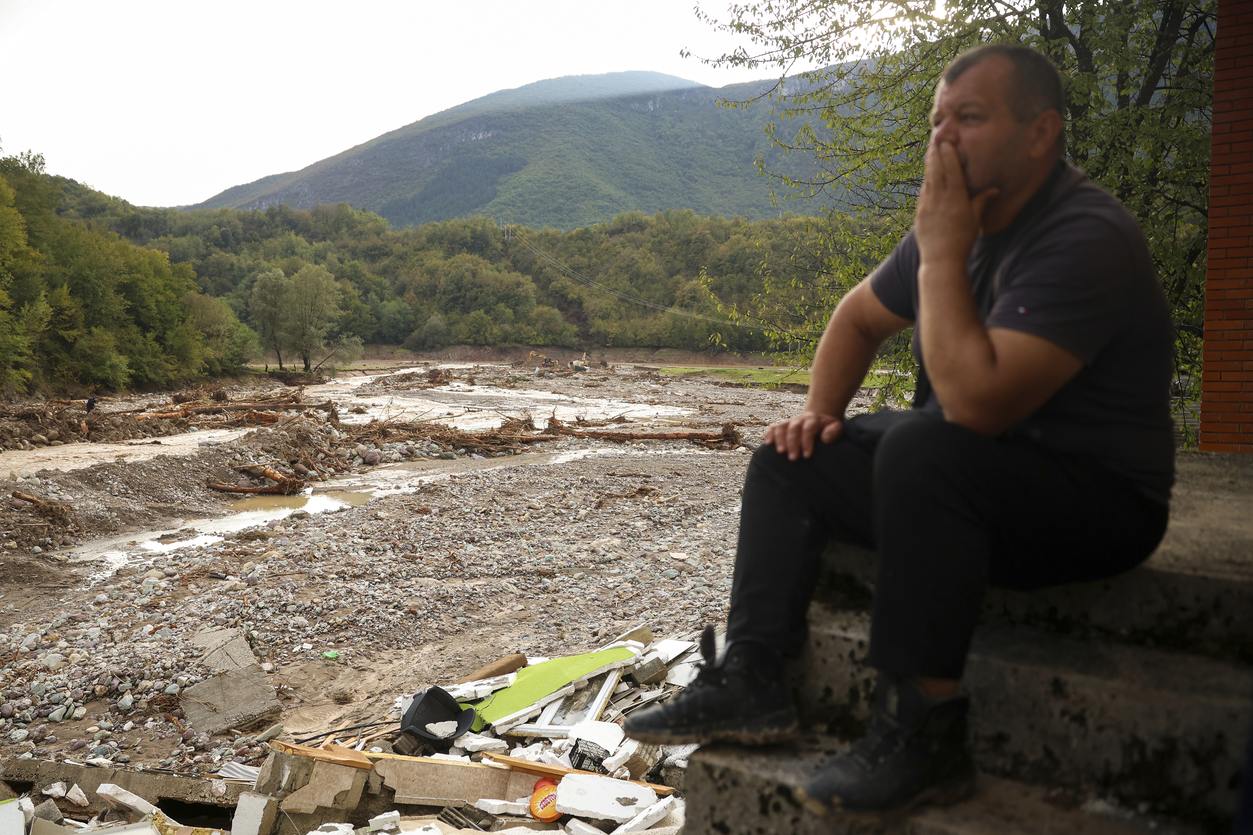 A man reacts as he looks at the destroyed houses following flooding in village of Buturovic Polje, Bosnia, Sunday, Oct. 6, 2024. (AP Photo/Armin Durgut)