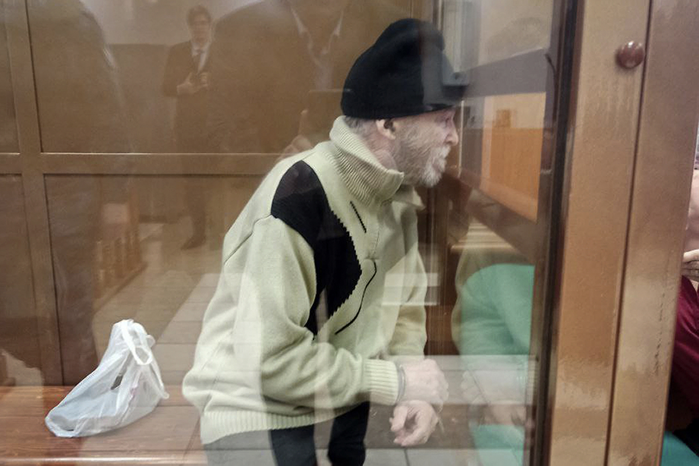 In this photo released by the Moscow City Court Press Service, Stephen Hubbard, a U.S. citizen accused of fighting as a mercenary in Ukraine against Russia sits in a glass cage during a court session in the Moscow City court in Moscow, Russia, Monday, Oct. 7, 2024. (Moscow City Court Press Service via AP)