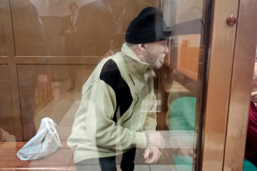 In this photo released by the Moscow City Court Press Service, Stephen Hubbard, a U.S. citizen accused of fighting as a mercenary in Ukraine against Russia sits in a glass cage during a court session in the Moscow City court in Moscow, Russia, Monday, Oct. 7, 2024. (Moscow City Court Press Service via AP)