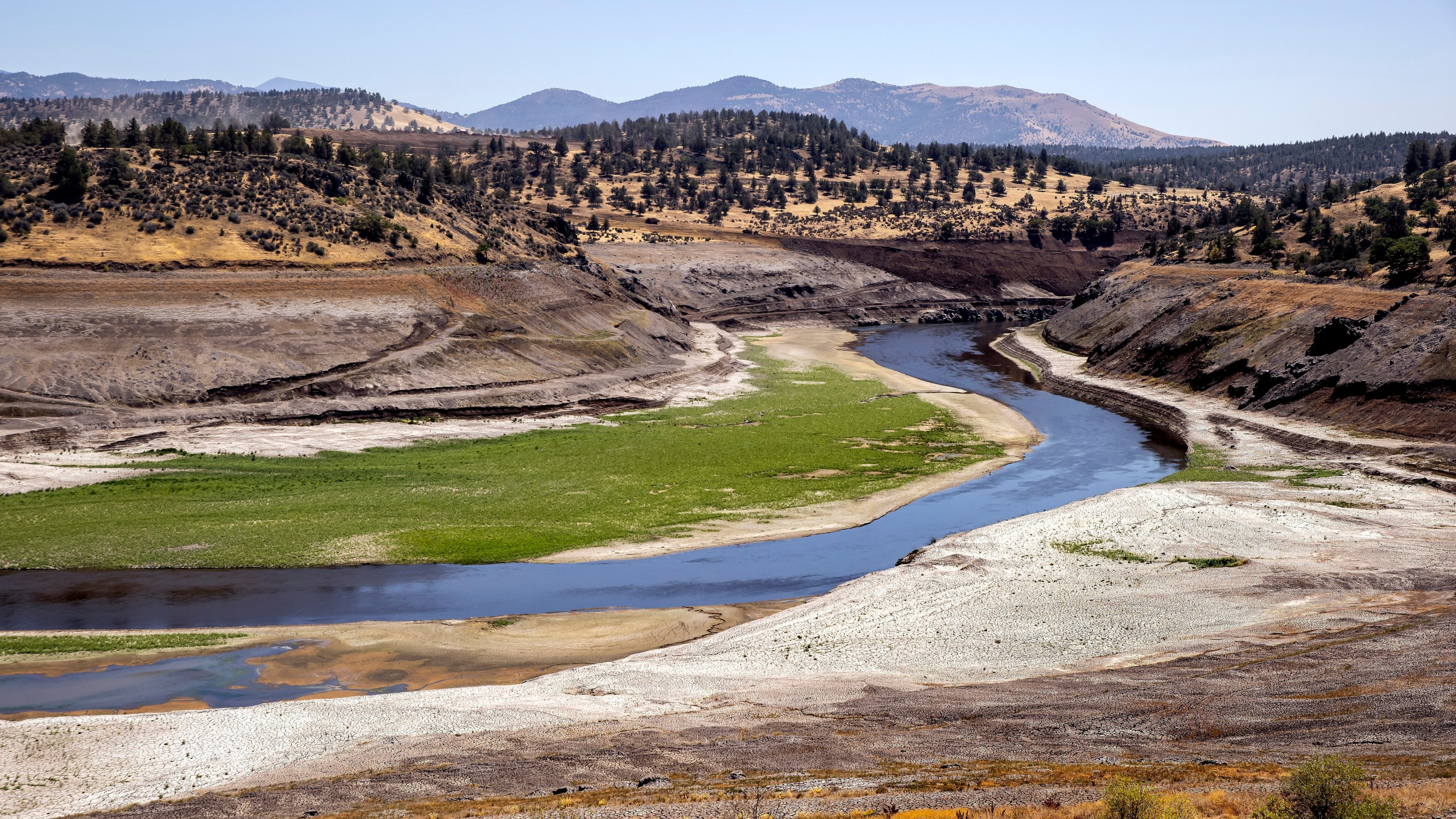 FILE - The Klamath River flows where Iron Gate Reservoir once was as work to remove of the Iron Gate and Copco Dams continues on the Klamath River near Hornbook, Calif., July 25, 2024. (Carlos Avila Gonzalez/San Francisco Chronicle via AP, File)