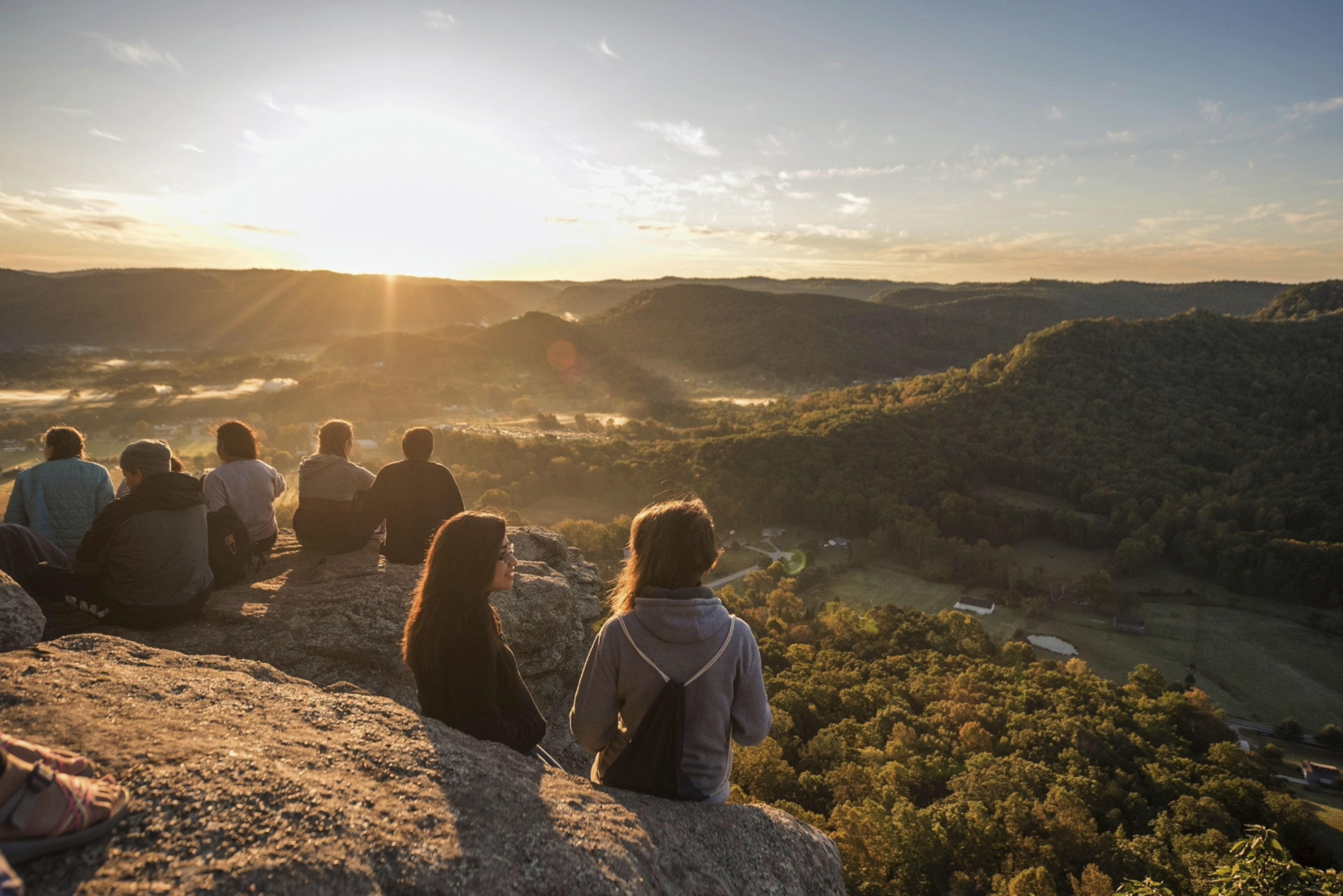 Students sit atop Indian Fort Mountain in Berea, Kentucky, during Berea College Mountain Day in Oct. 2023, an annual event held to celebrate the surrounding Appalachian region. The Partners for Rural Impact are taking a philanthropic model from Harlem and adapting it for Appalachian Kentucky. (Partners for Rural Impact via AP)