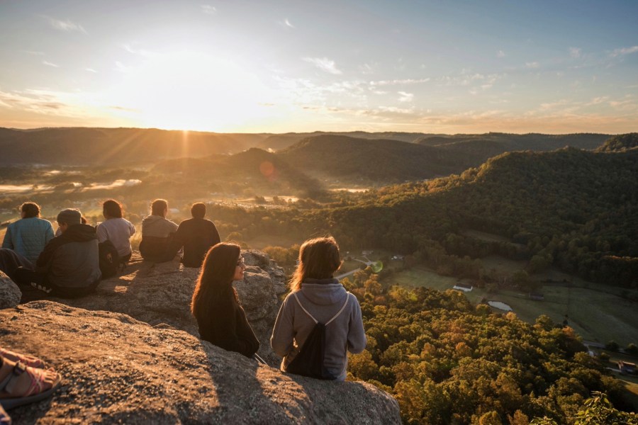 Students sit atop Indian Fort Mountain in Berea, Kentucky, during Berea College Mountain Day in Oct. 2023, an annual event held to celebrate the surrounding Appalachian region. The Partners for Rural Impact are taking a philanthropic model from Harlem and adapting it for Appalachian Kentucky. (Partners for Rural Impact via AP)