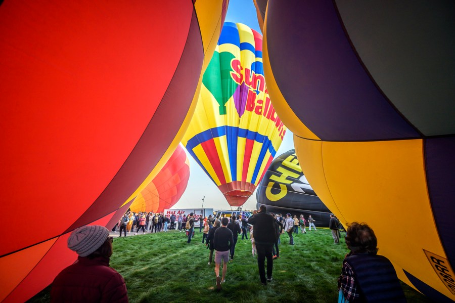 Spectators watch as hot air balloons take off during the mass ascension at the 52nd Albuquerque International Balloon Fiesta in Albuquerque, N.M., on Saturday, Oct. 5, 2024. (AP Photo/Roberto E. Rosales)