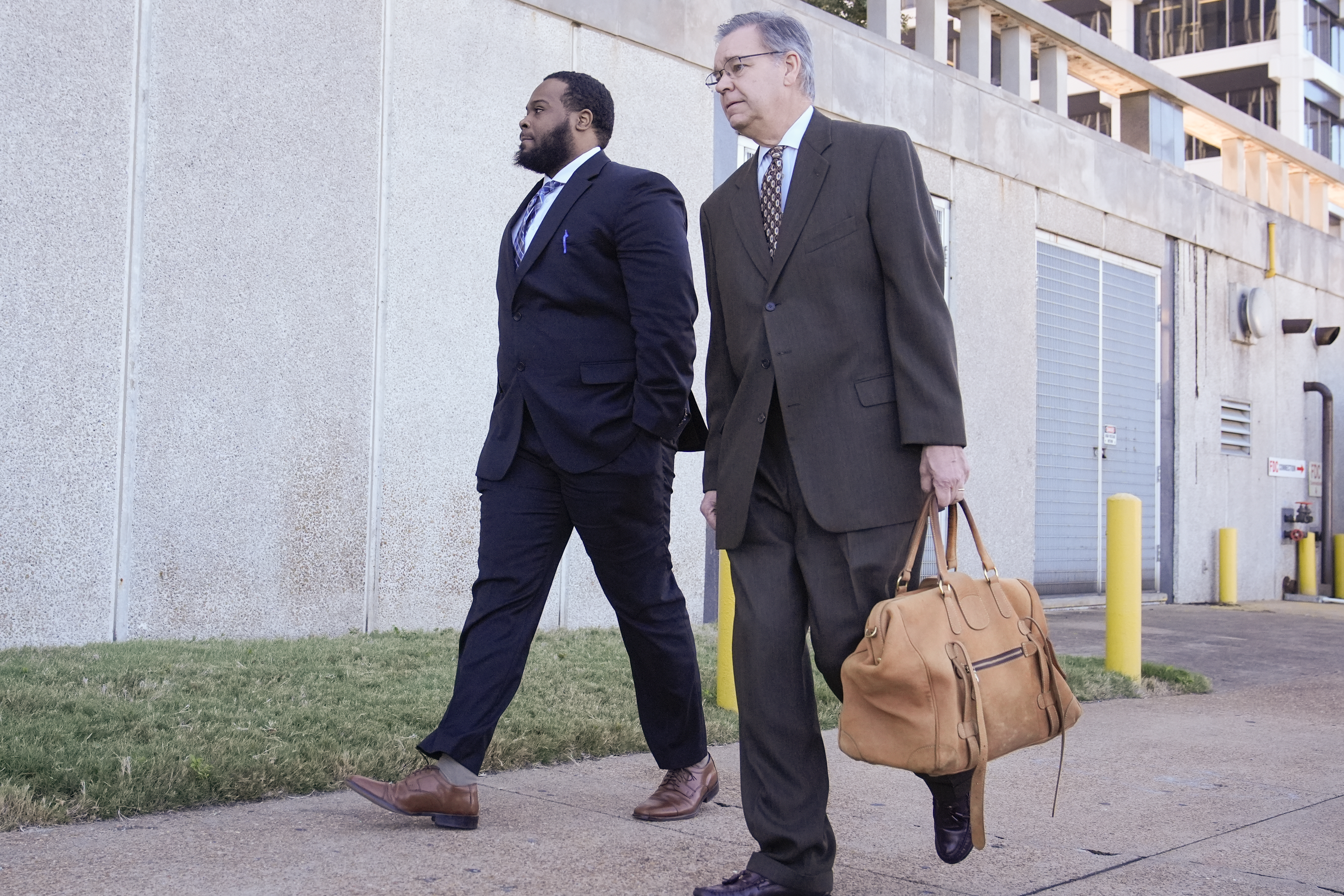 Demetrius Haley, left, one of three former Memphis police officers charged in the 2023 fatal beating of Tyre Nichols, arrives at the federal courthouse with his attorney Michael Stengel, right, for the day's proceedings Thursday, Oct. 3, 2024, in Memphis, Tenn. (AP Photo/George Walker IV)