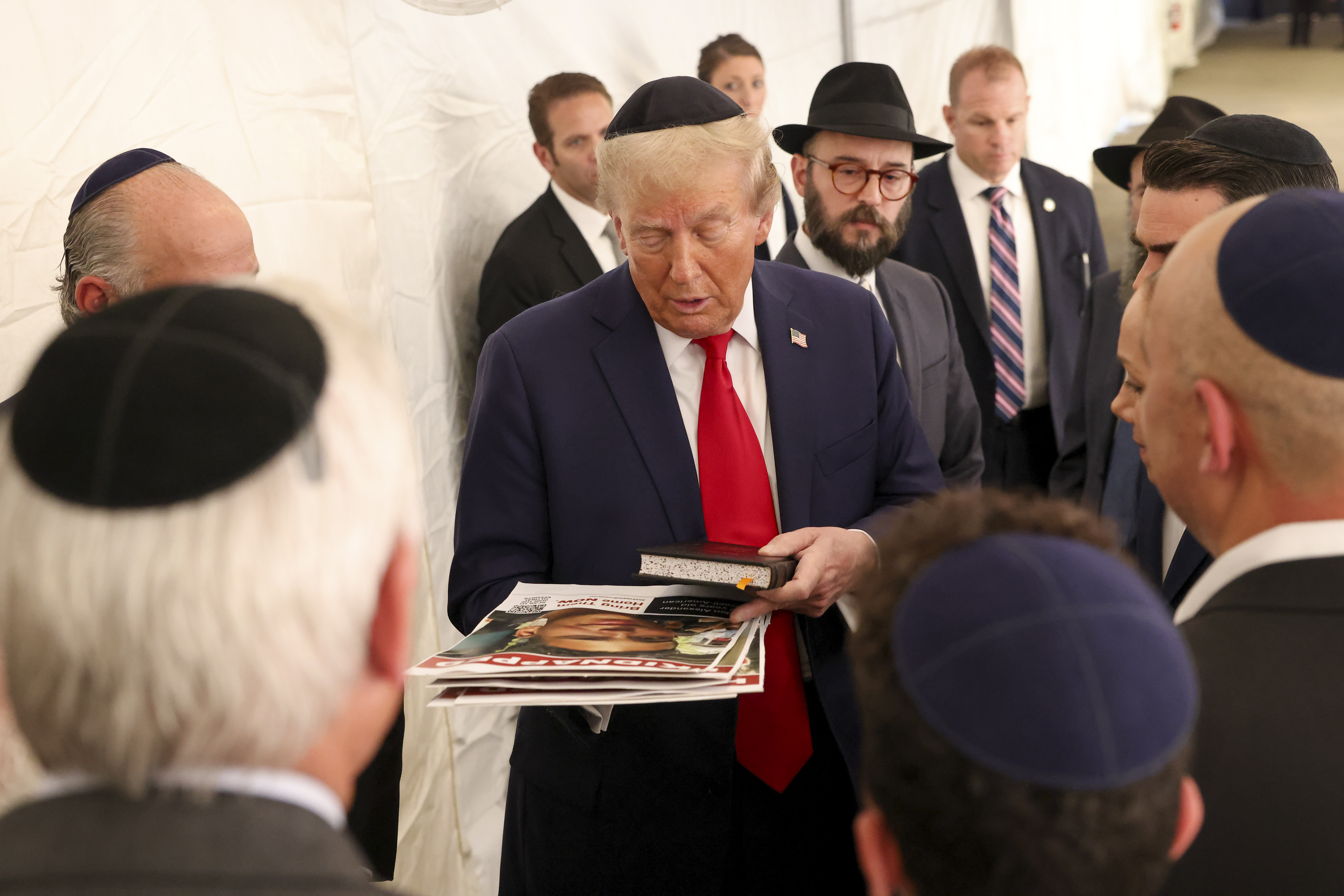 Republican presidential nominee former President Donald Trump talks with members of the Chabad Lubavitch after visiting the gravesite of Rabbi Menachem Mendel Schneerson, Monday, Oct. 7, 2024, in New York. (AP Photo/Yuki Iwamura)